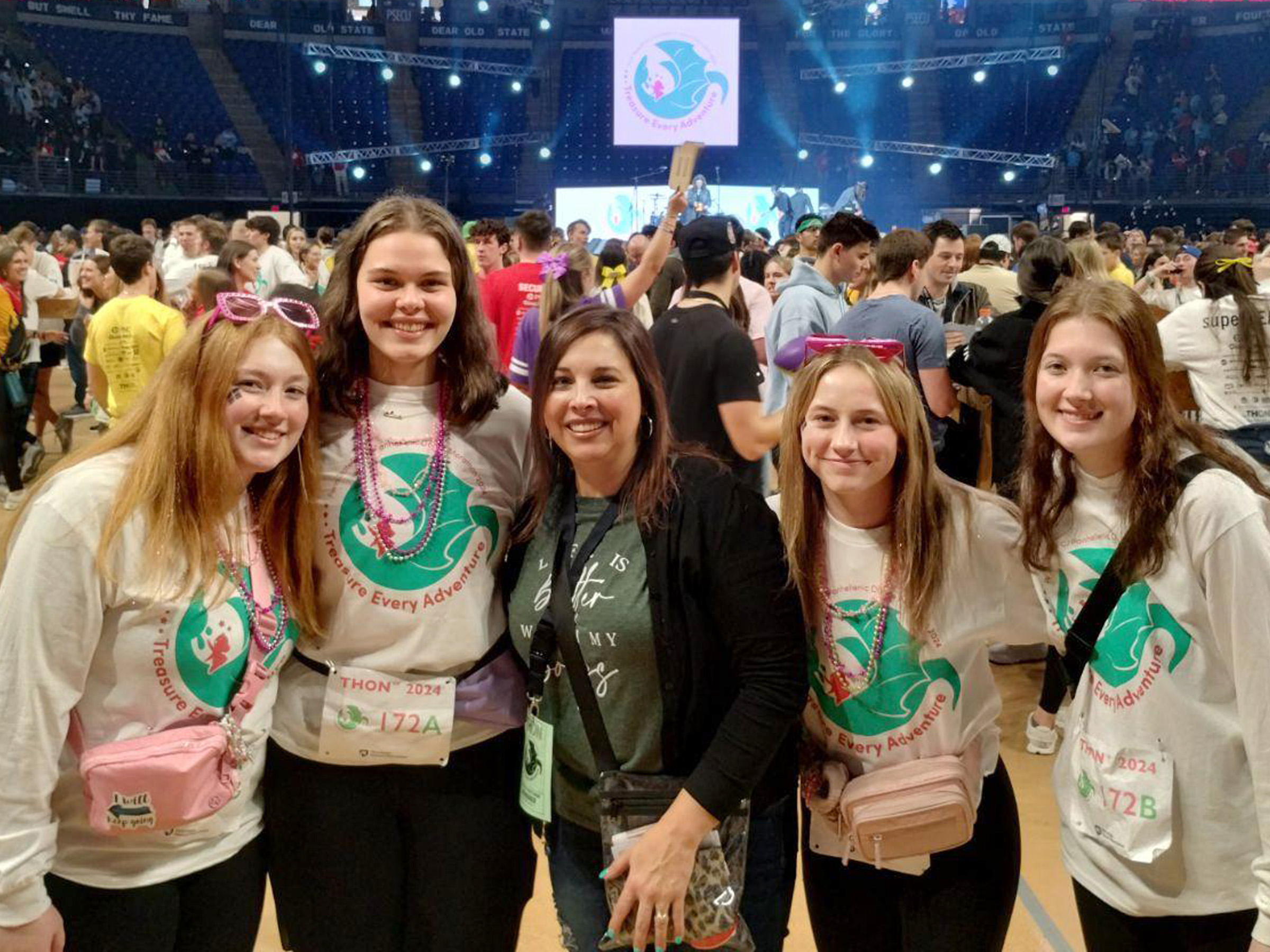 THON dancers from Penn State DuBois gather on the floor at the Bryce Jordan Center during the 46-hour dance marathon for a photo. From left to right, Ella Wilson, Rachel Allegretto, director of student affairs at Penn State DuBois Rebecca Pennington, Madee Finalle and Abigail Morgo.