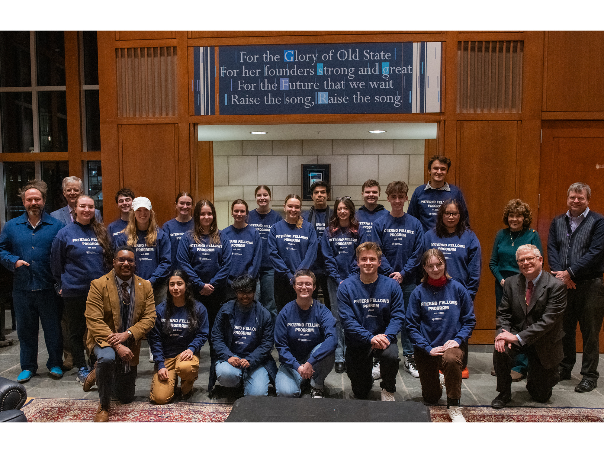 The newest class of Paterno Fellows stands in front of the Alma Mater in the Hintz Family Alumni Center.