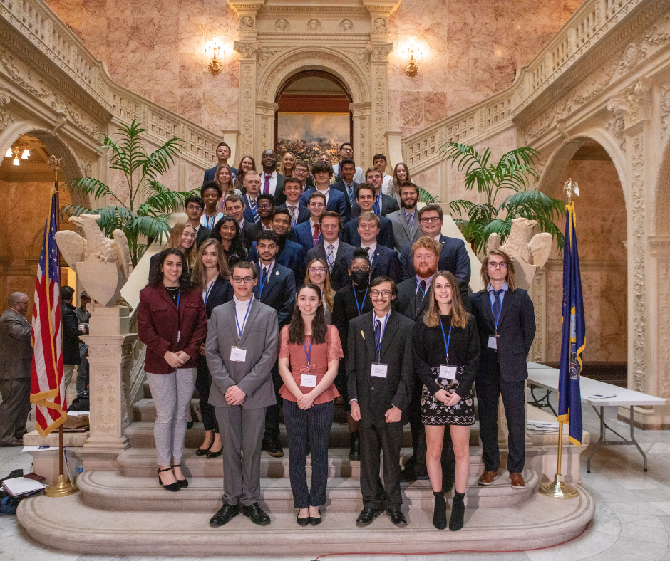 students standing on steps in an ornate room in the Pennsylvania capitol building