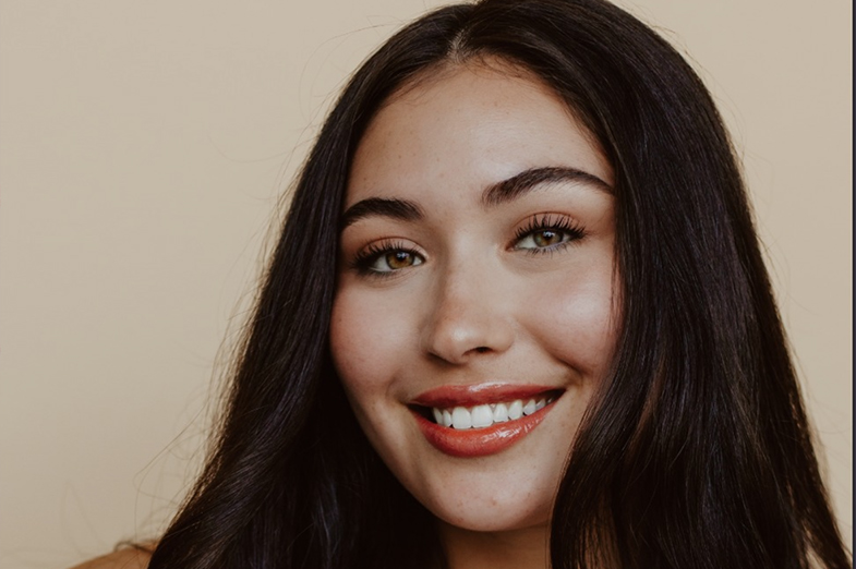 Young woman with dark hair smiling