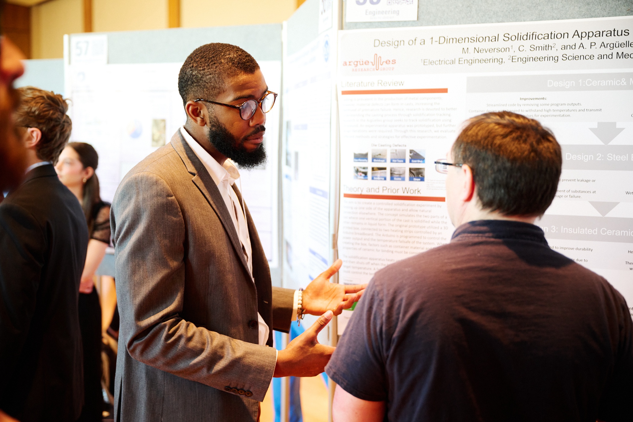 Student presenting research poster to faculty judge at 2023 Exhibition