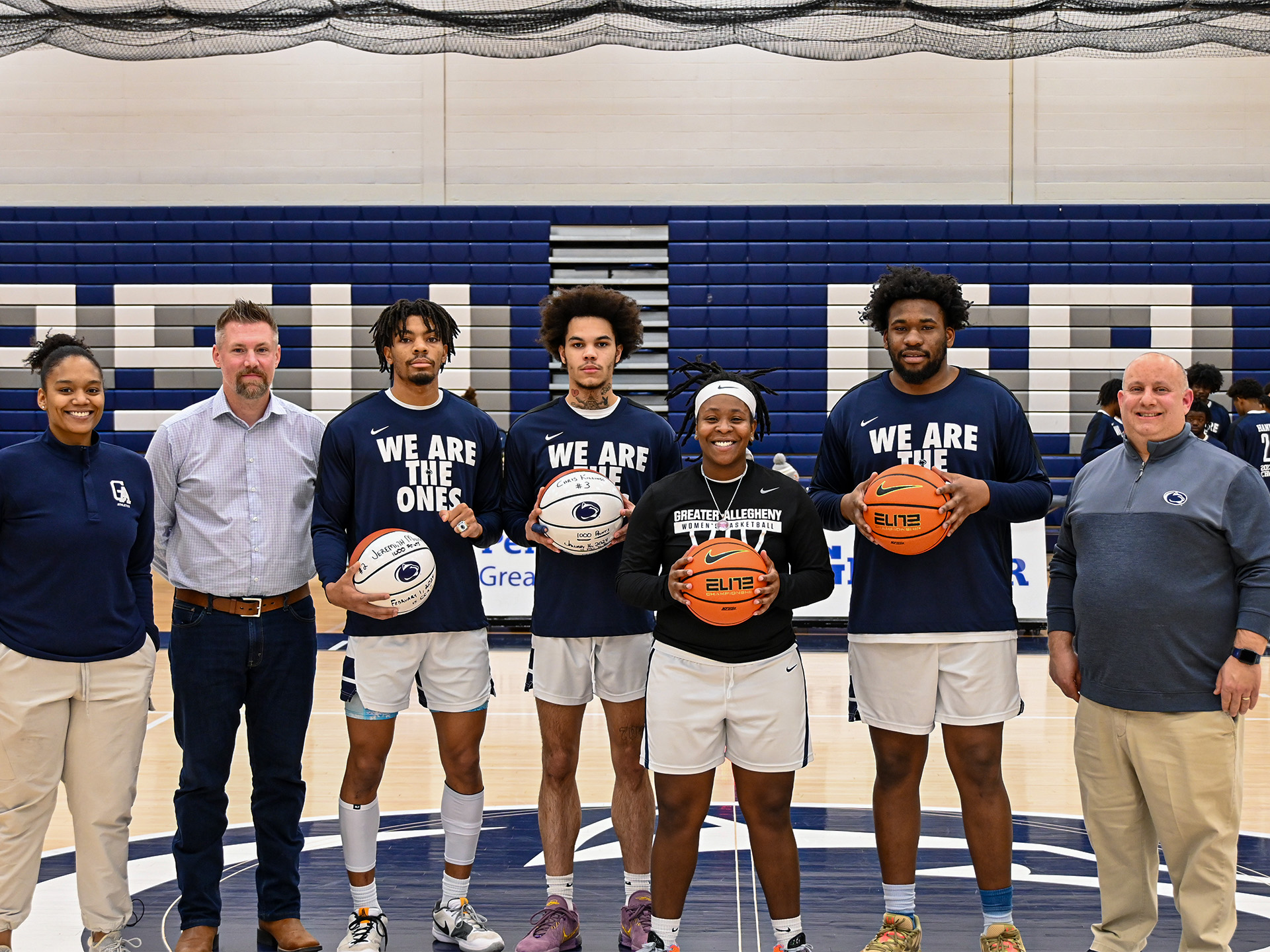 people standing and holding basketballs