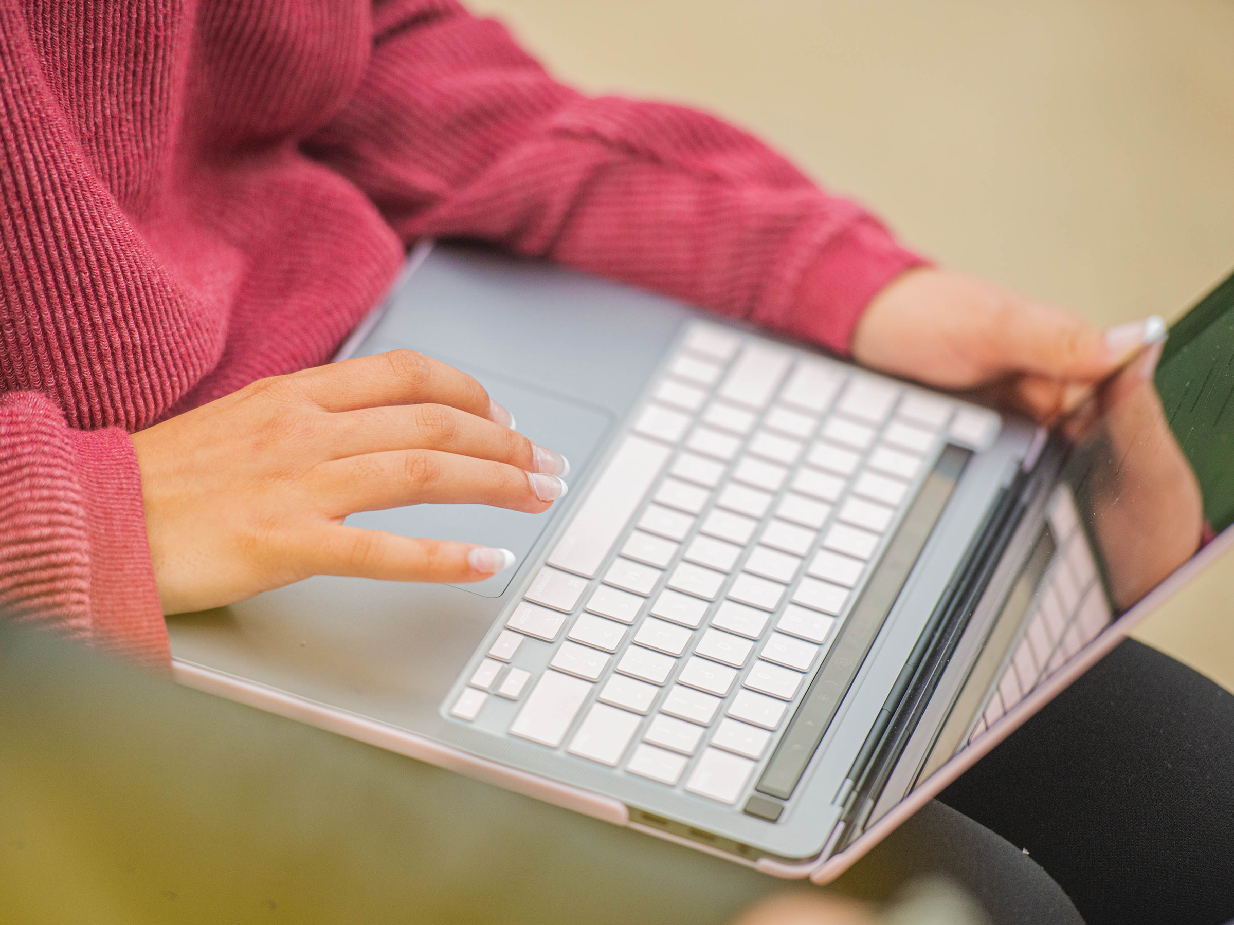 Student typing on a laptop