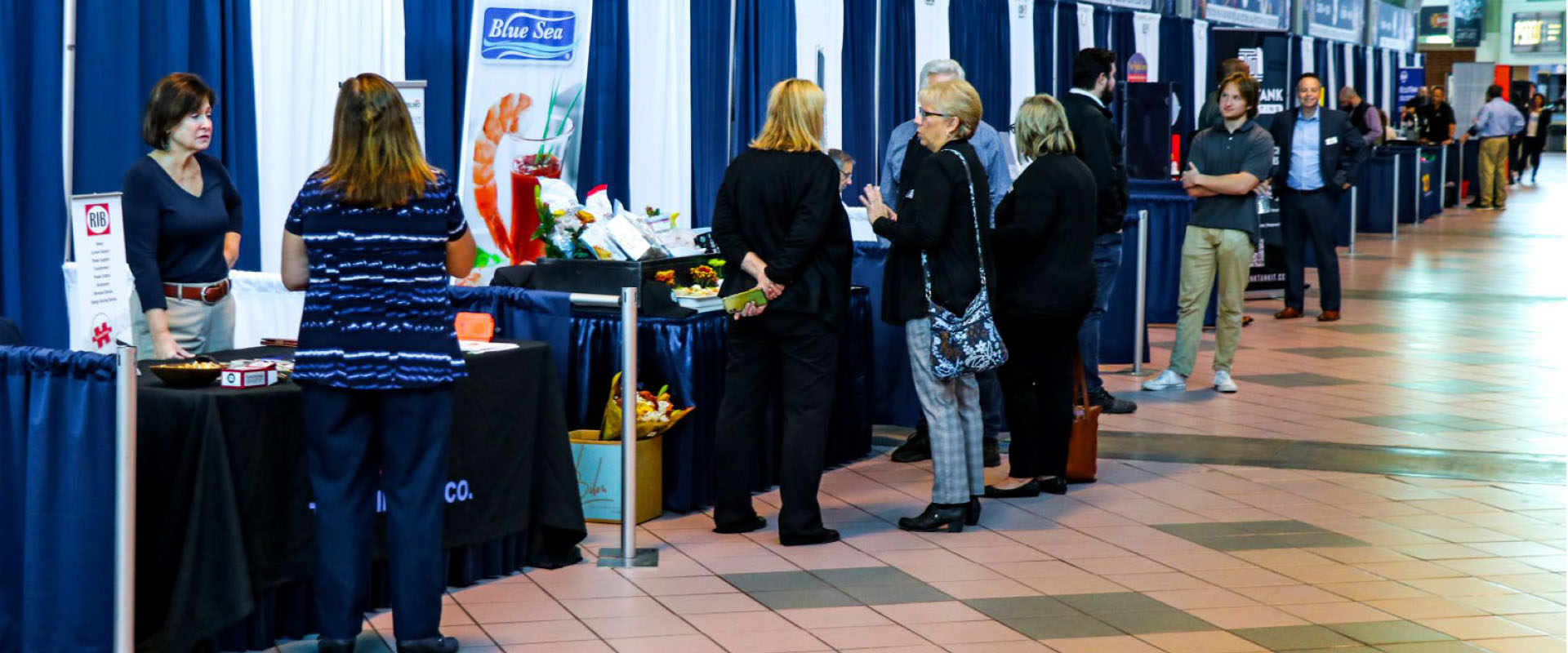 Shoppers and suppliers interacting at the Bryce Jordan Center