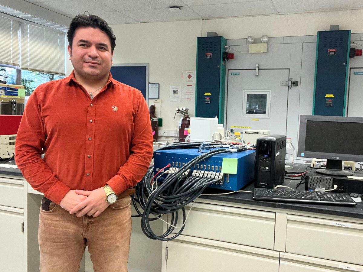 Arash Emdadi poses for a photo in his research lab