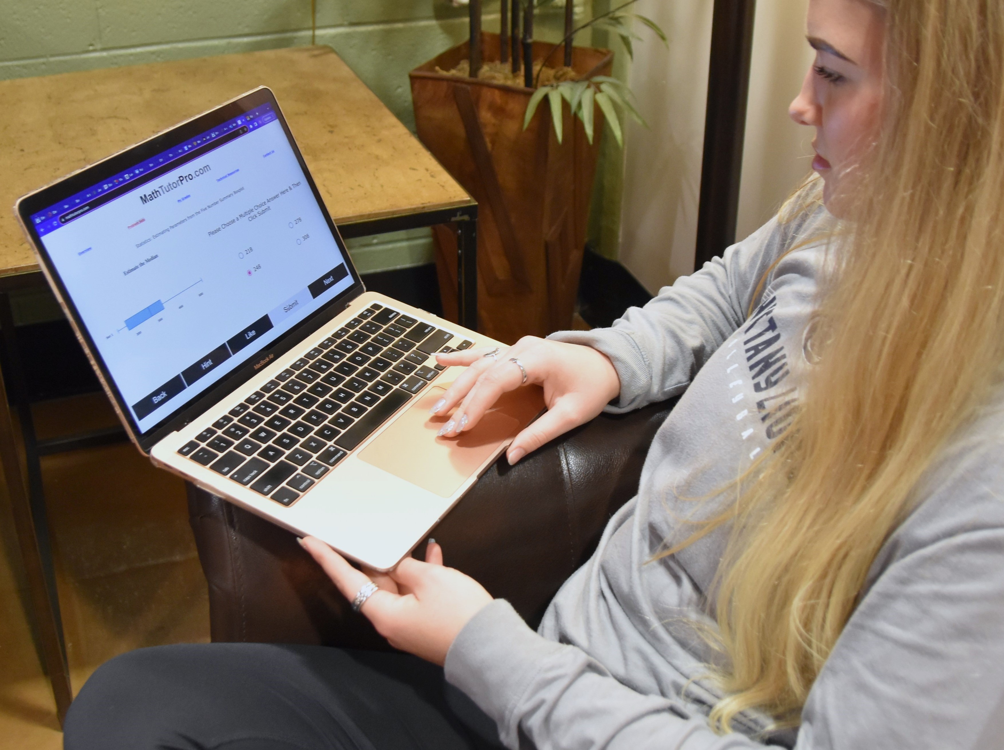 Female student looking at laptop computer.