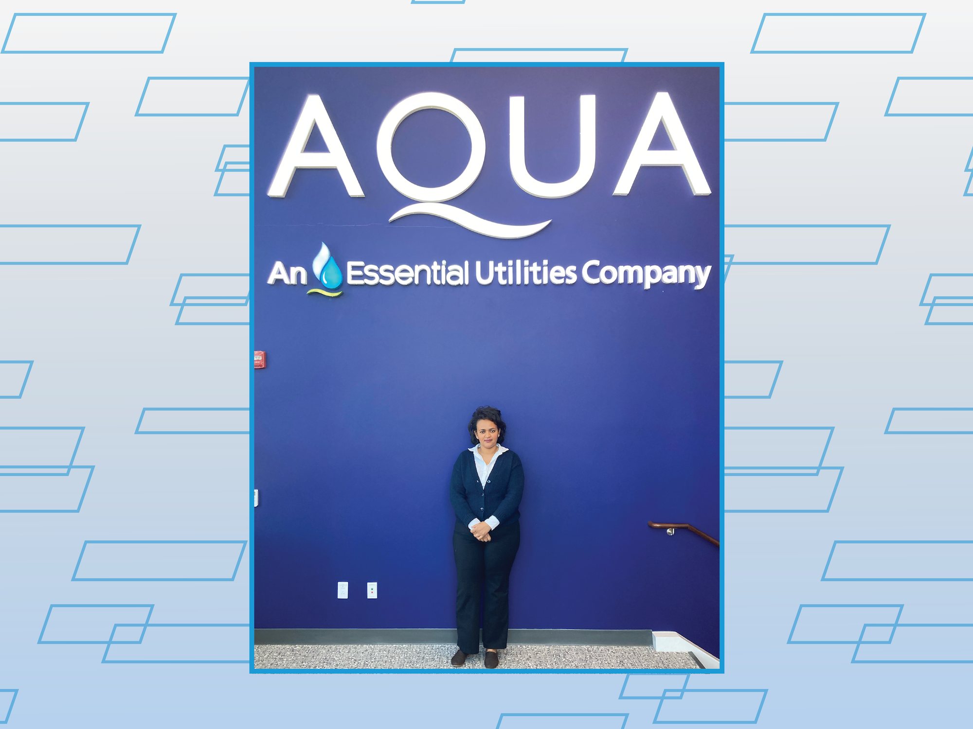 Nuhamin standing by Aqua sign 