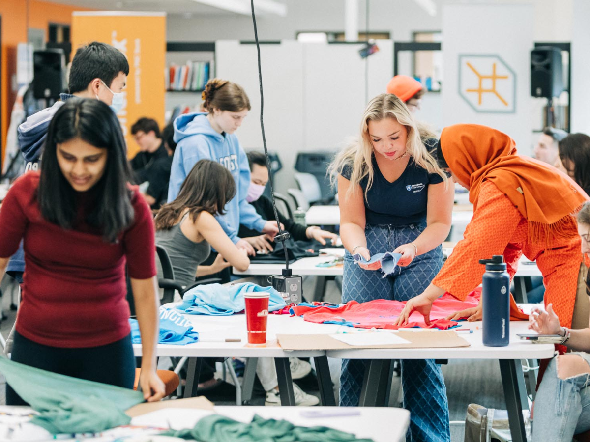 Students designing clothing during an event taking place at Happy Valley LaunchBox powered by PNC Bank