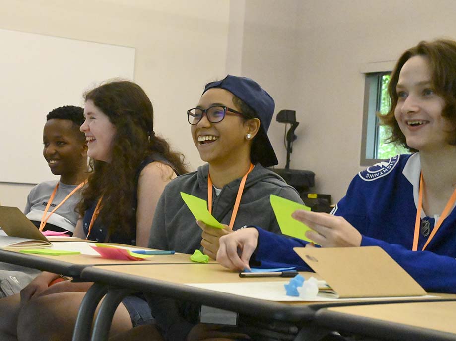 Four students sitting at a table during a class