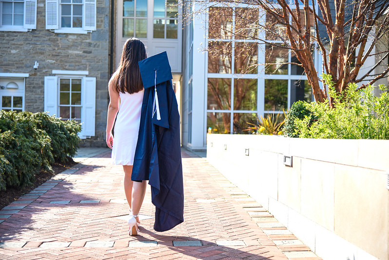 graduate walking down sidewalk