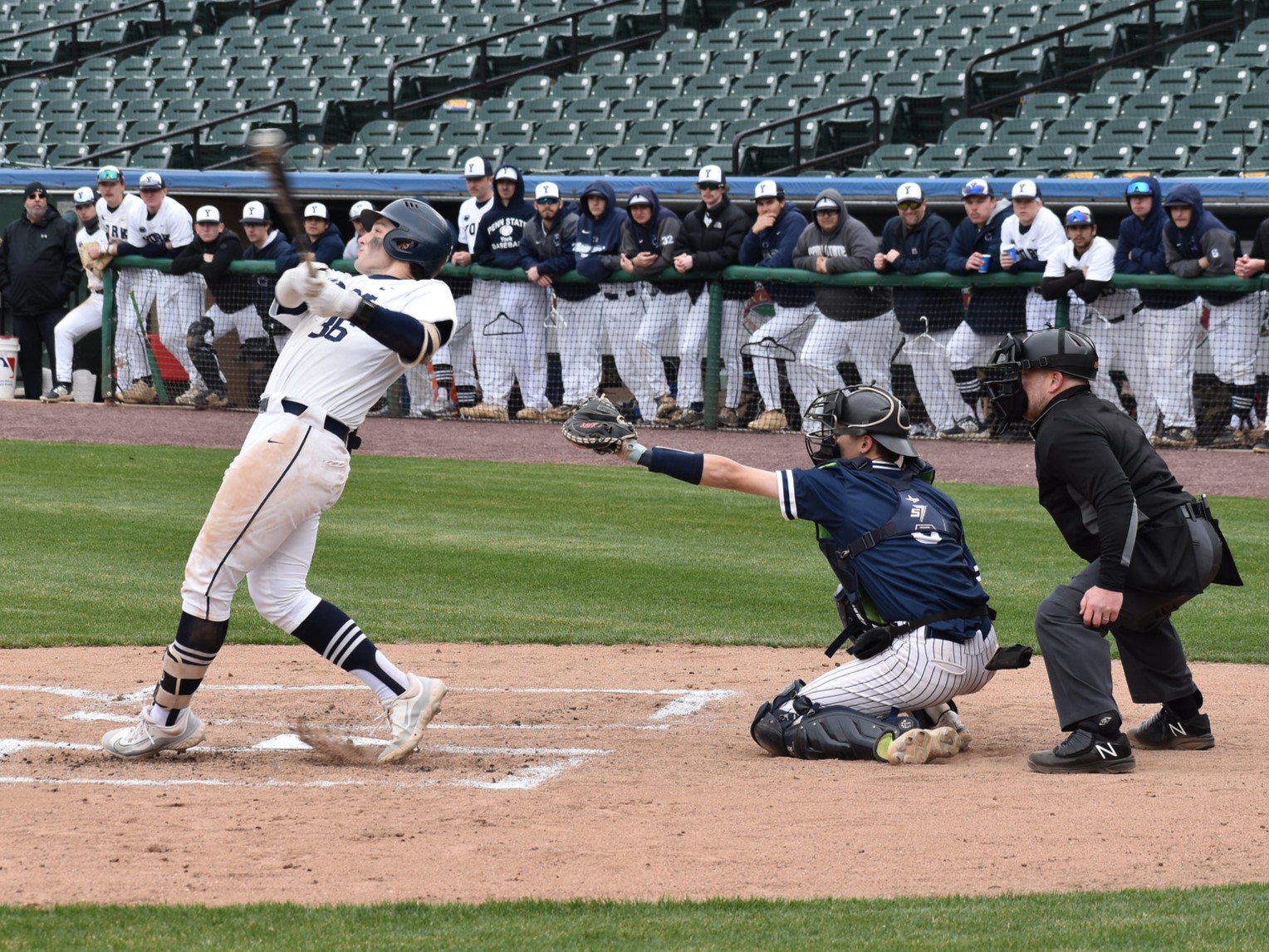 Baseball player swinging a bat.