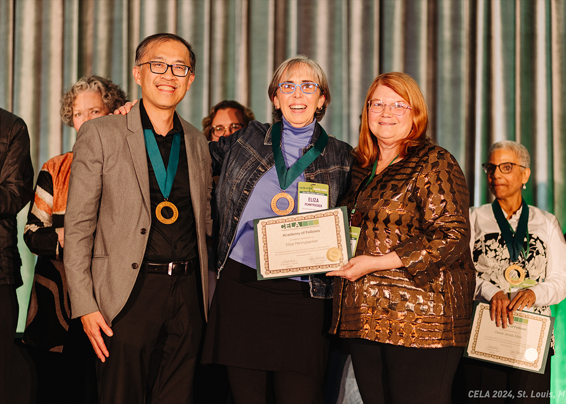 Eliza Pennypacker, at center, accepts a certificate from a woman on her right and a man on her left. 