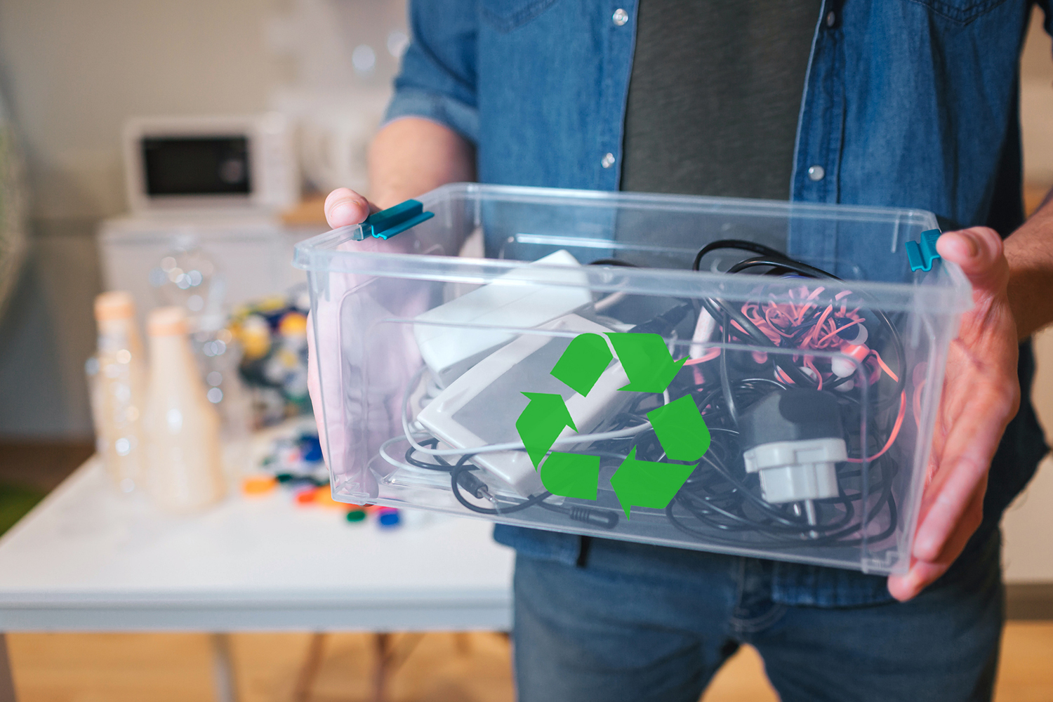 Person holding a bin of recyclable electronic devices