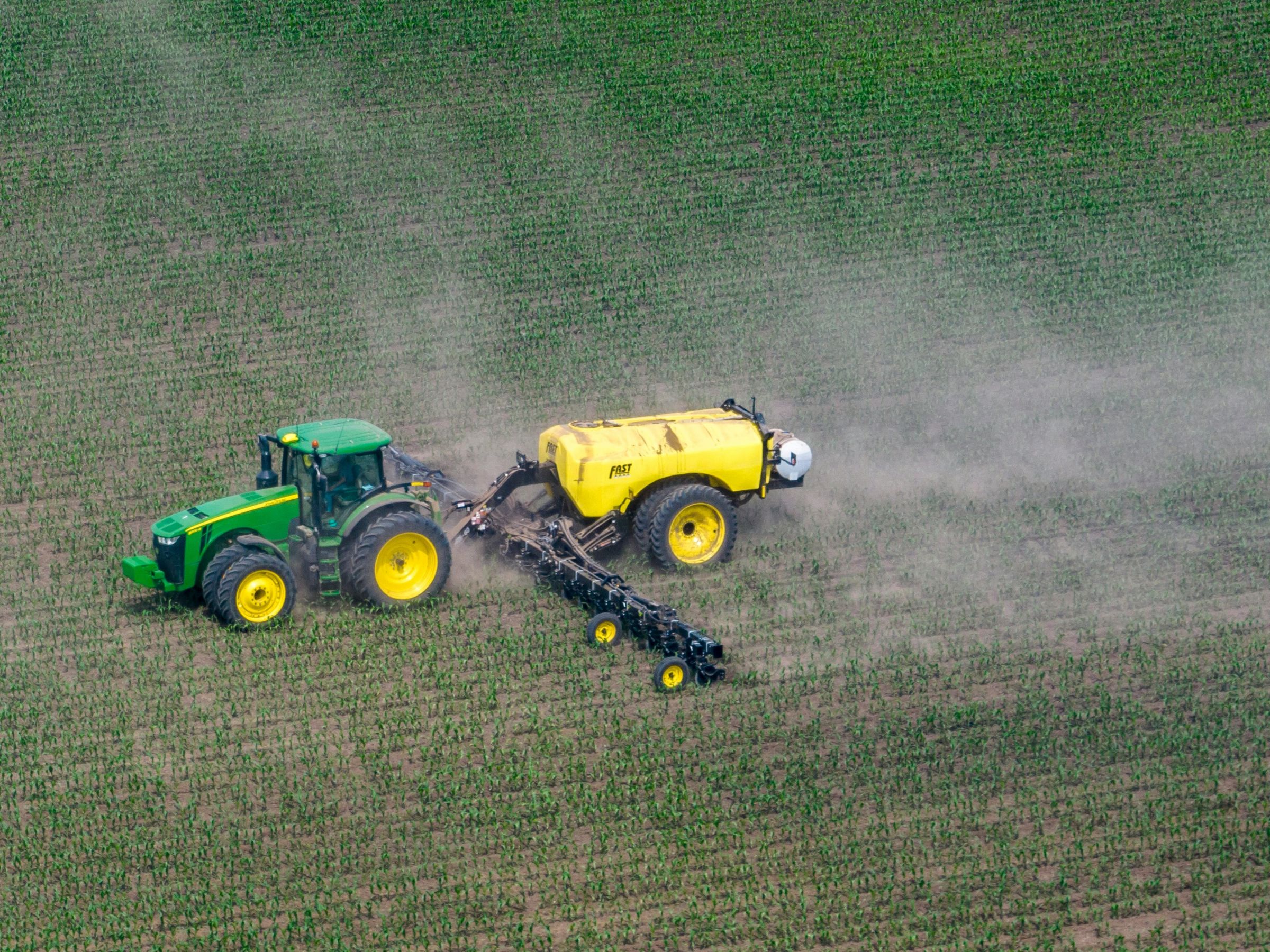 A producer applies fertilizer to a corn crop