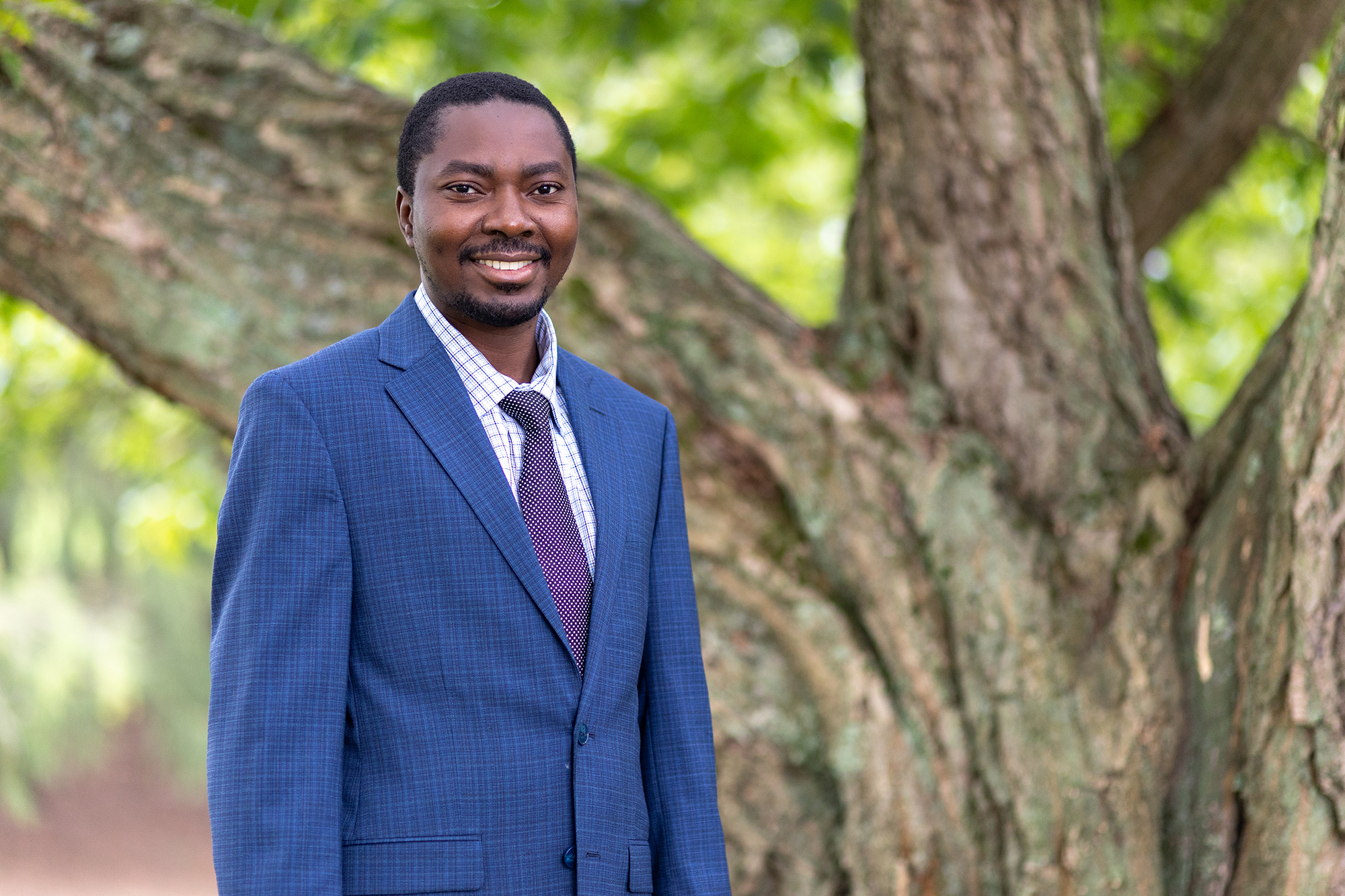 A person wearing a shirt, tie and blue suit jacket. 