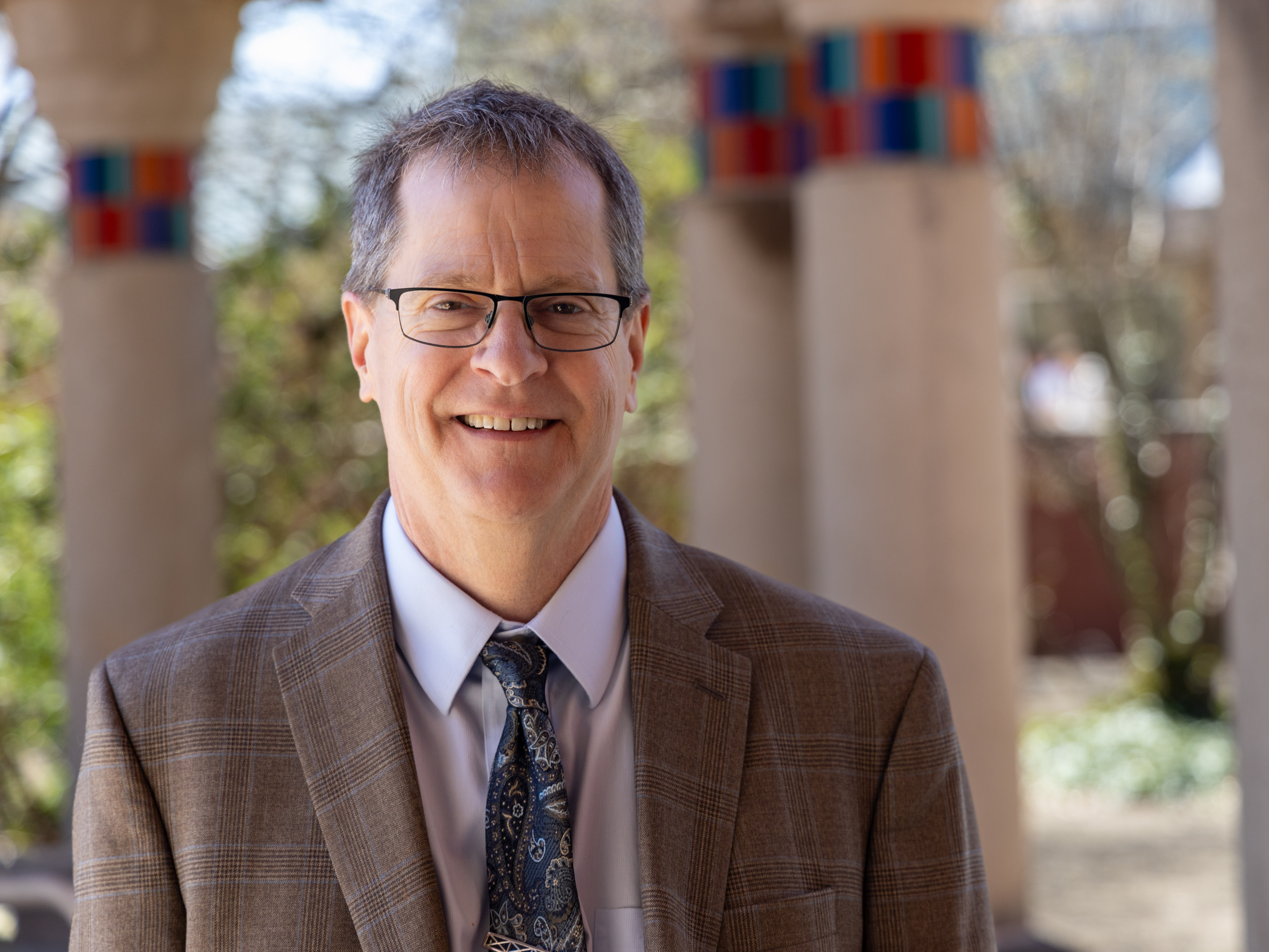 Headshot of Mark Morrisson standing on campus 