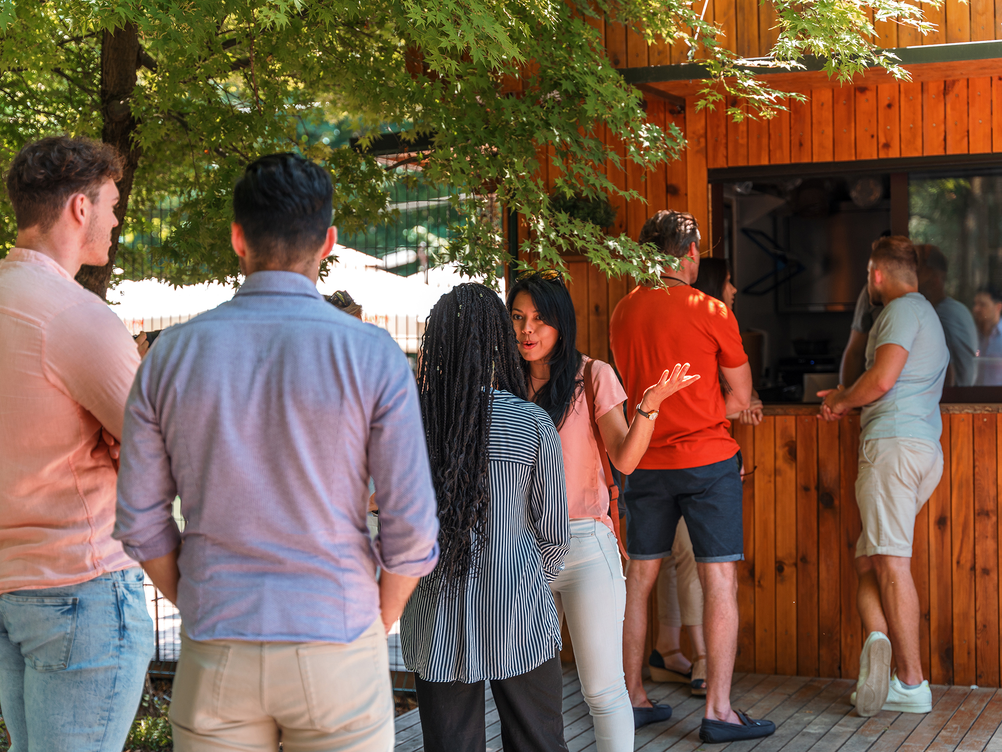 Group of people waiting in a line to get food