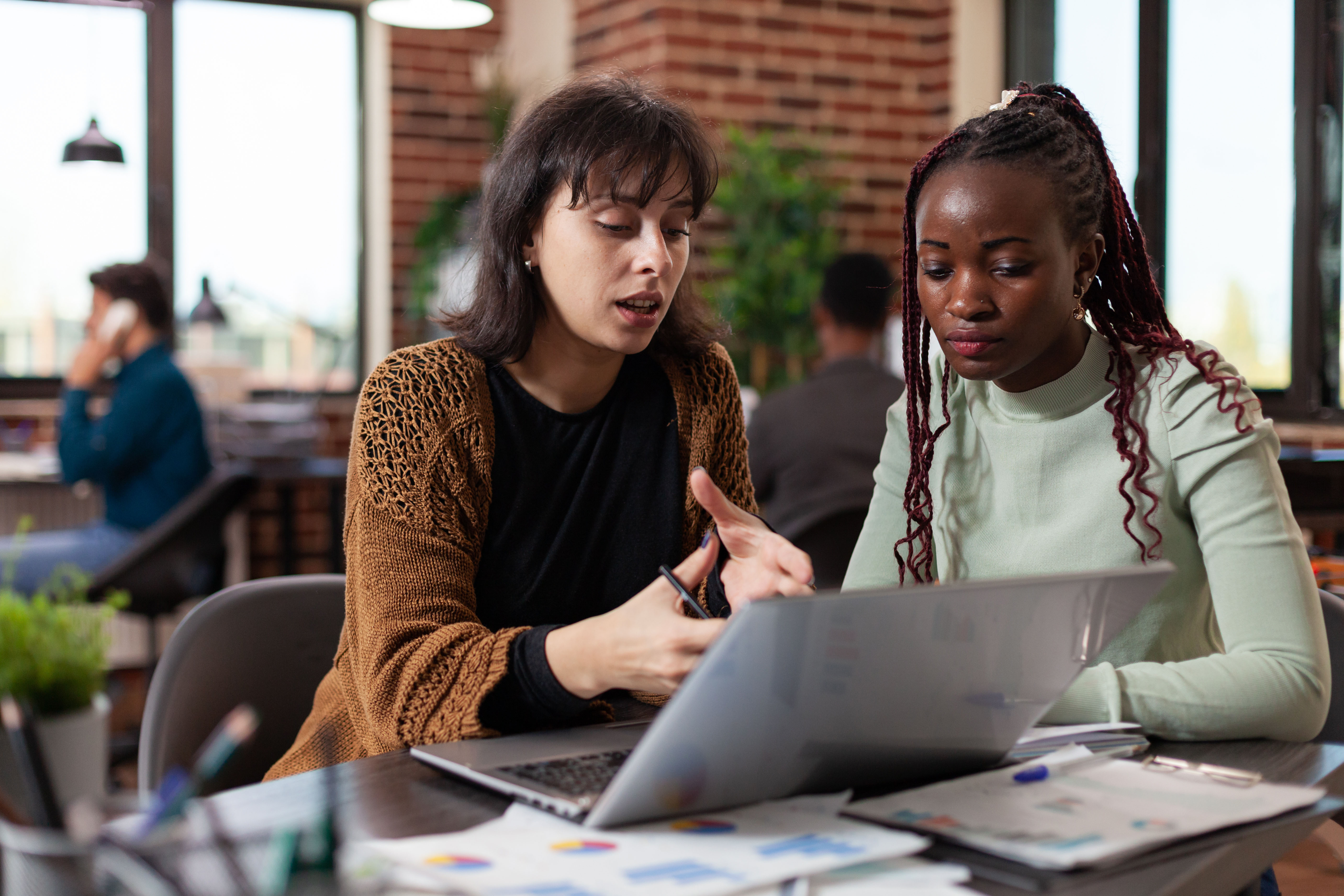 Two people looking at a laptop