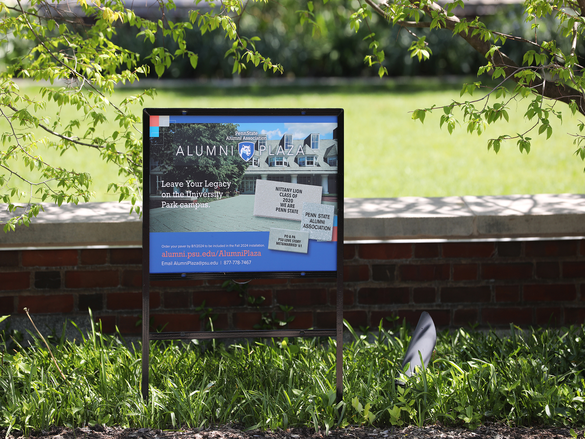 Alumni Plaza sign in front of Alumni Center