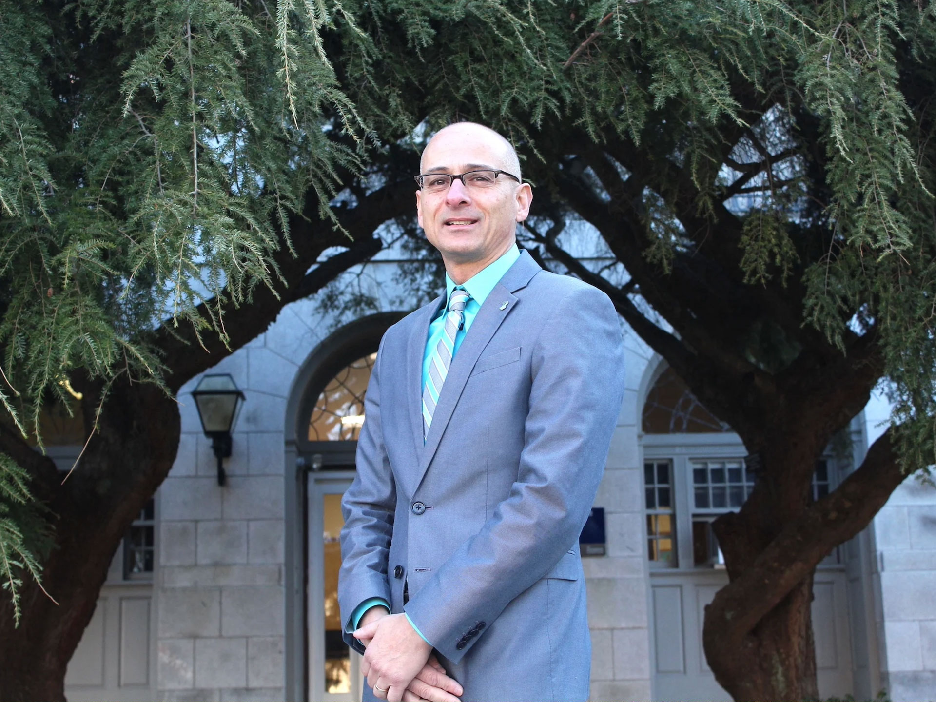 Gary Liquori standing in front of a building