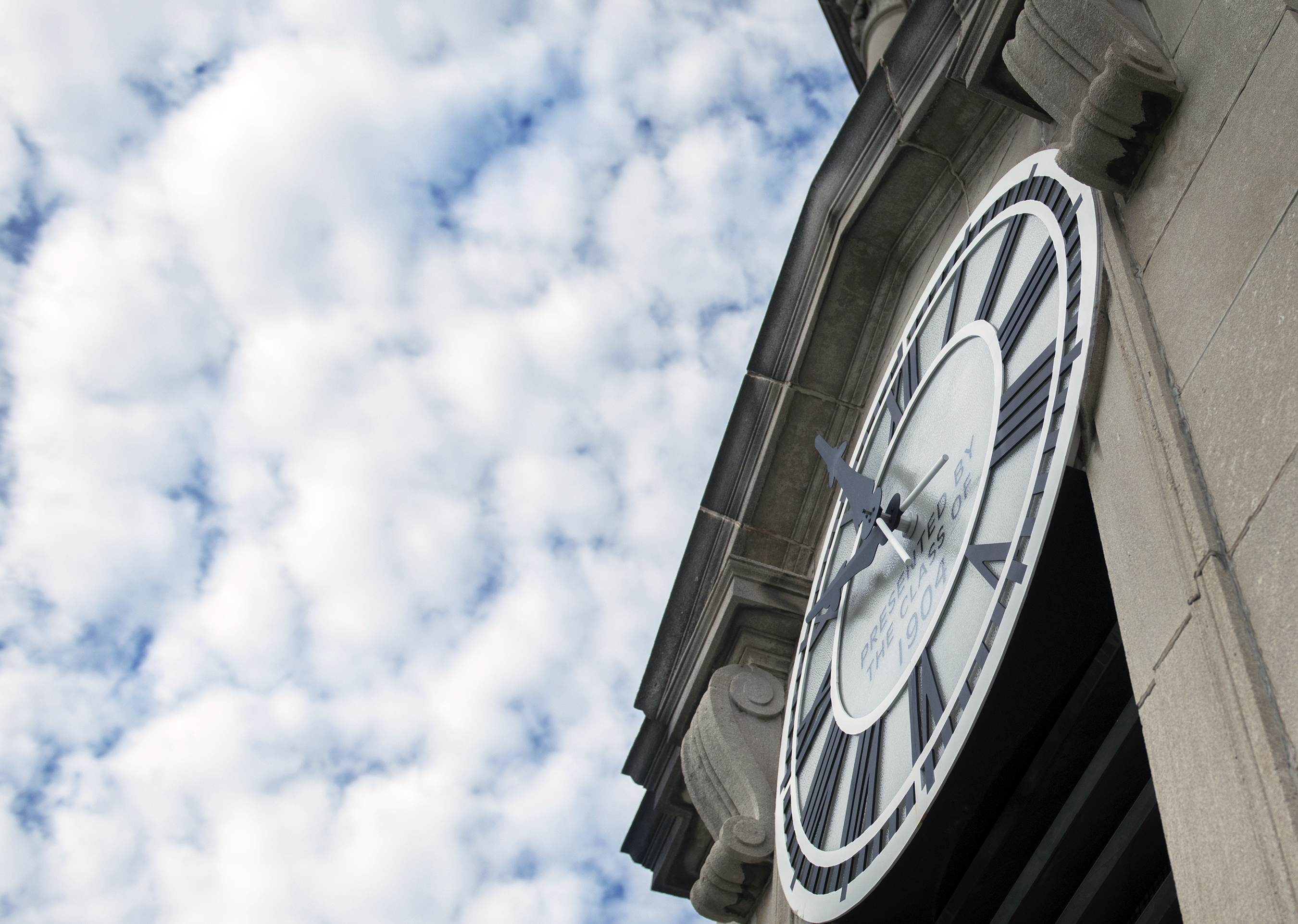 Old Main clock to the right, with clouds pictured above