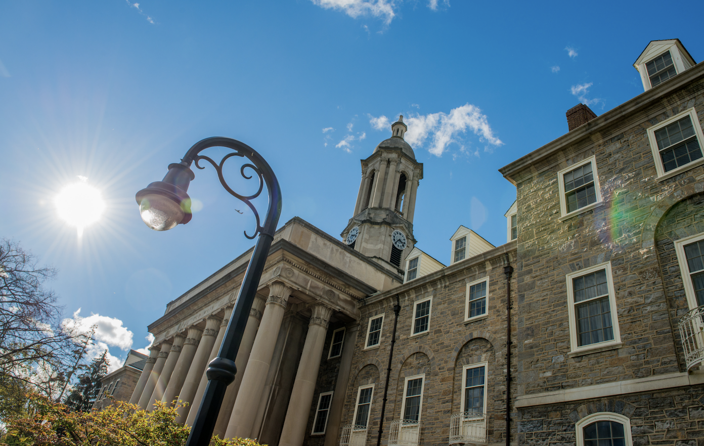 detail photo of Penn State Old Main building with sunny sky