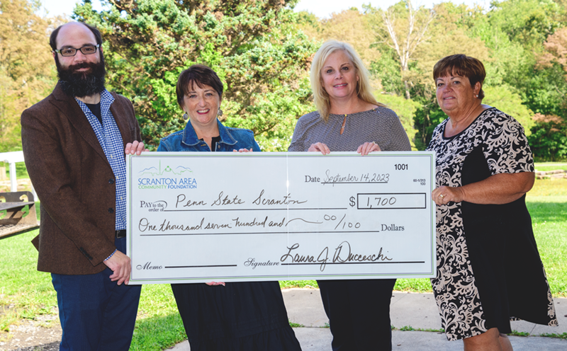 Scranton Foundation reps and Director of Development Chris Ostroski pose with grant check