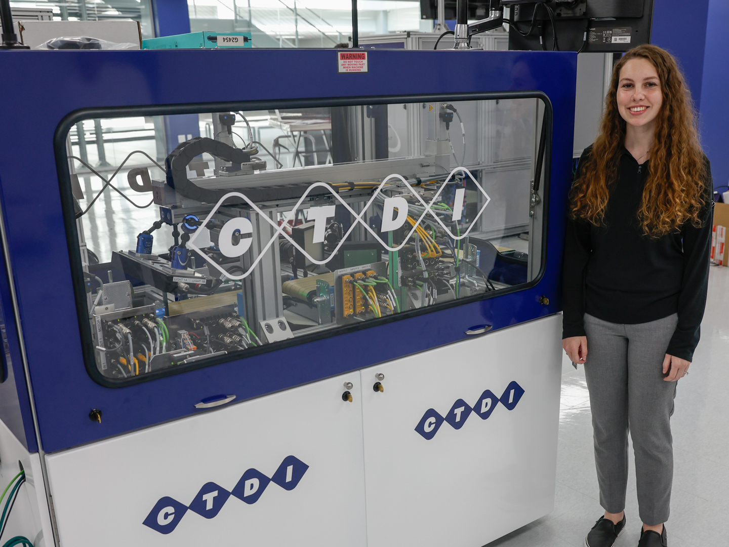 A person stands next to an engineering machine.