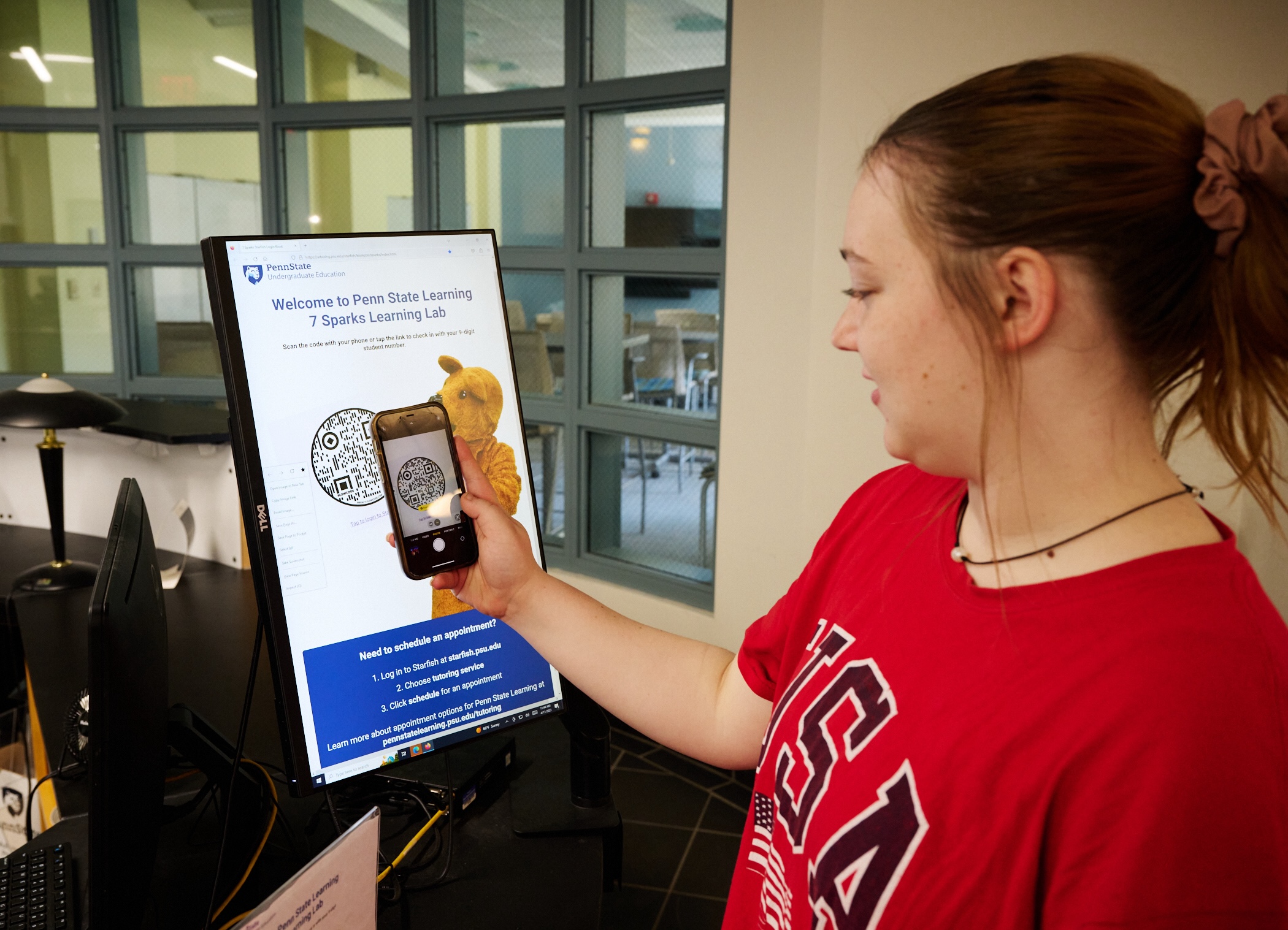 Penn State student scans Penn State Learning QR code with her smartphone.