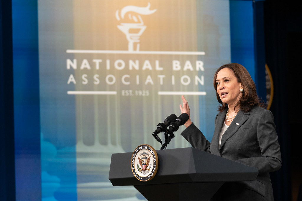 Kamala Harris at a podium with a National Bar Association banner in the background