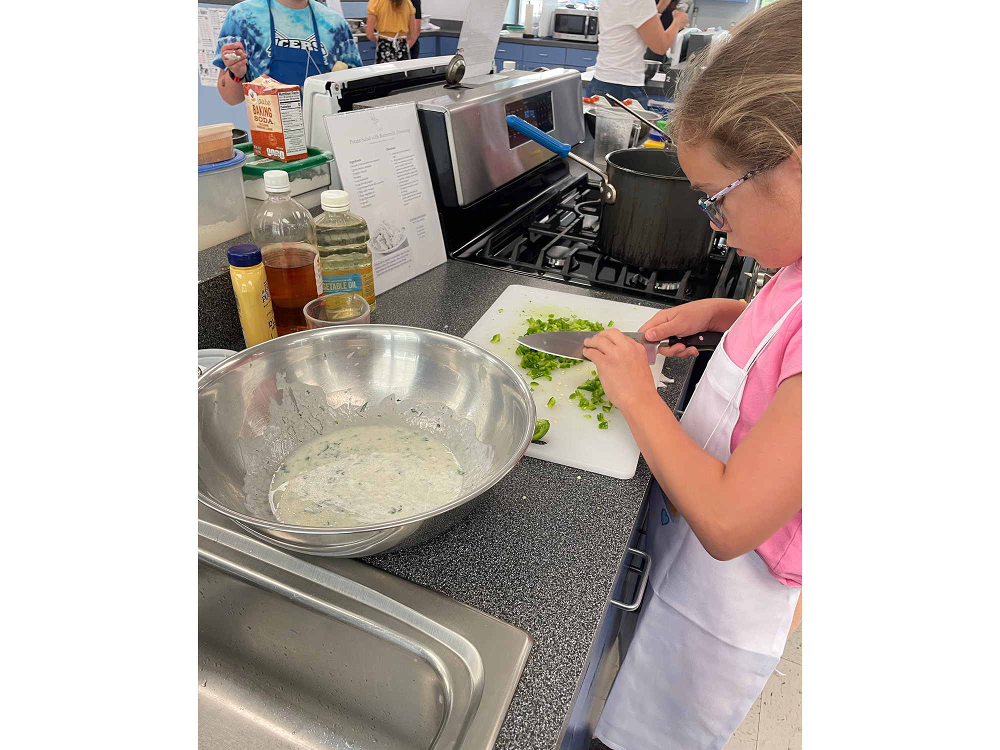 A child chops vegetables 