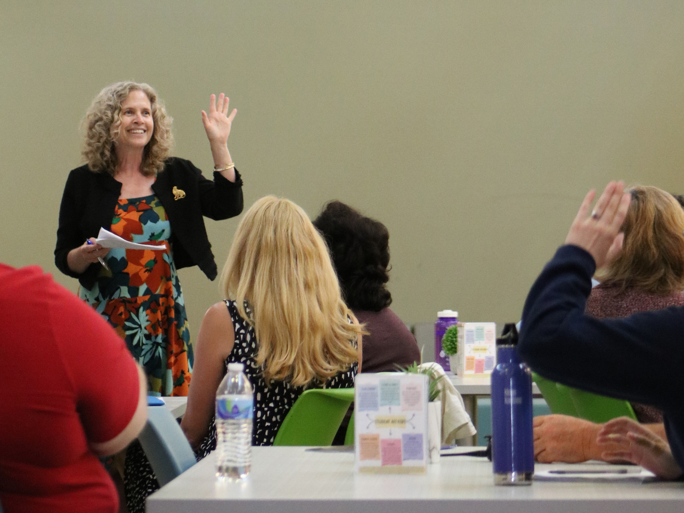 Carey McDougall waves to faculty and staff members