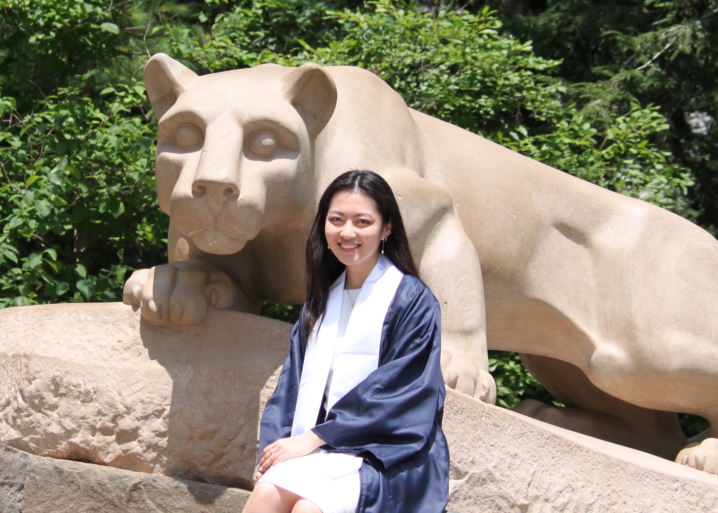 Yuki Yoshida, the student marshal for the summer 2024 semester, posing with the Nittany Lion Shrine