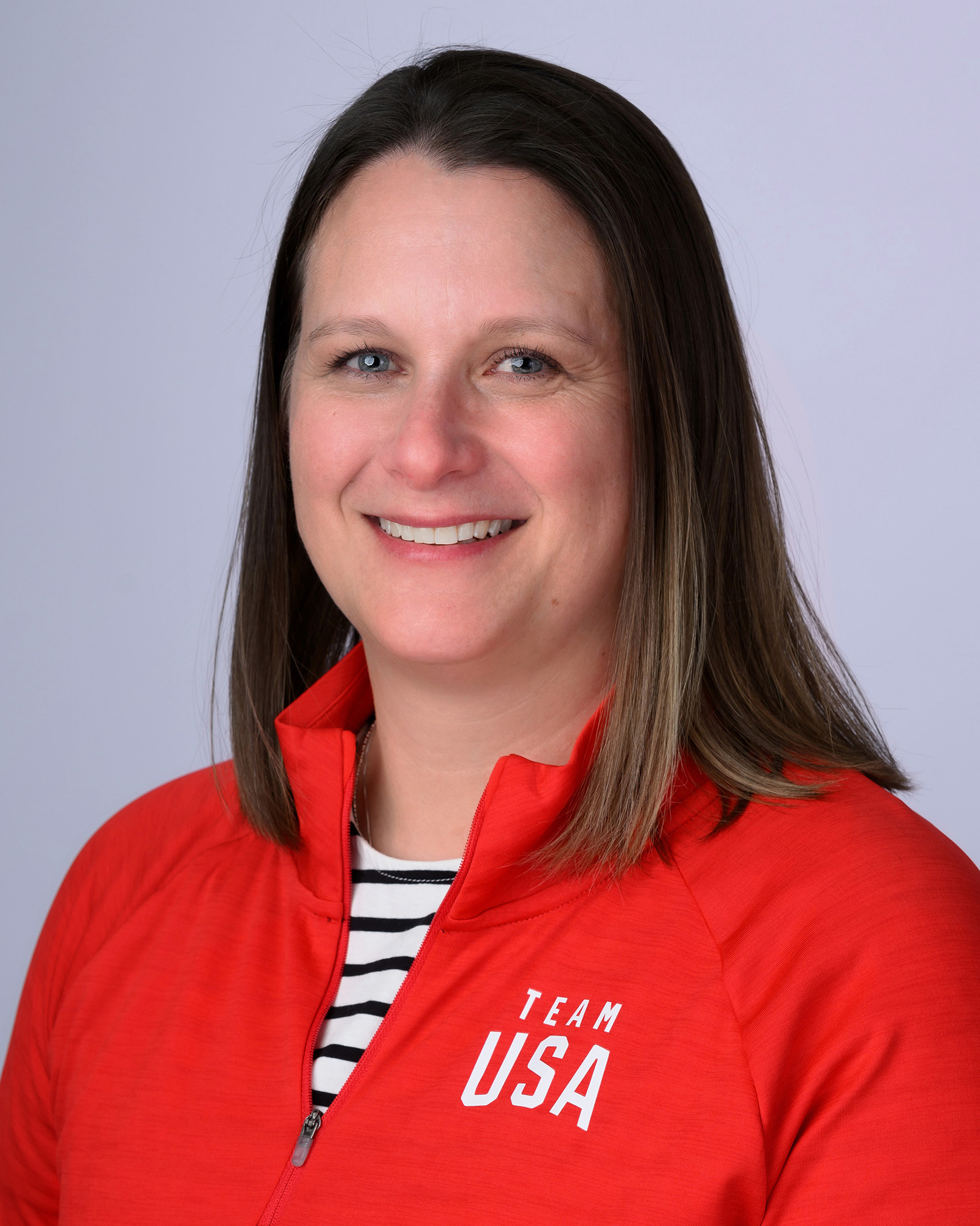 A headshot of a woman wearing a red Team USA jacket.