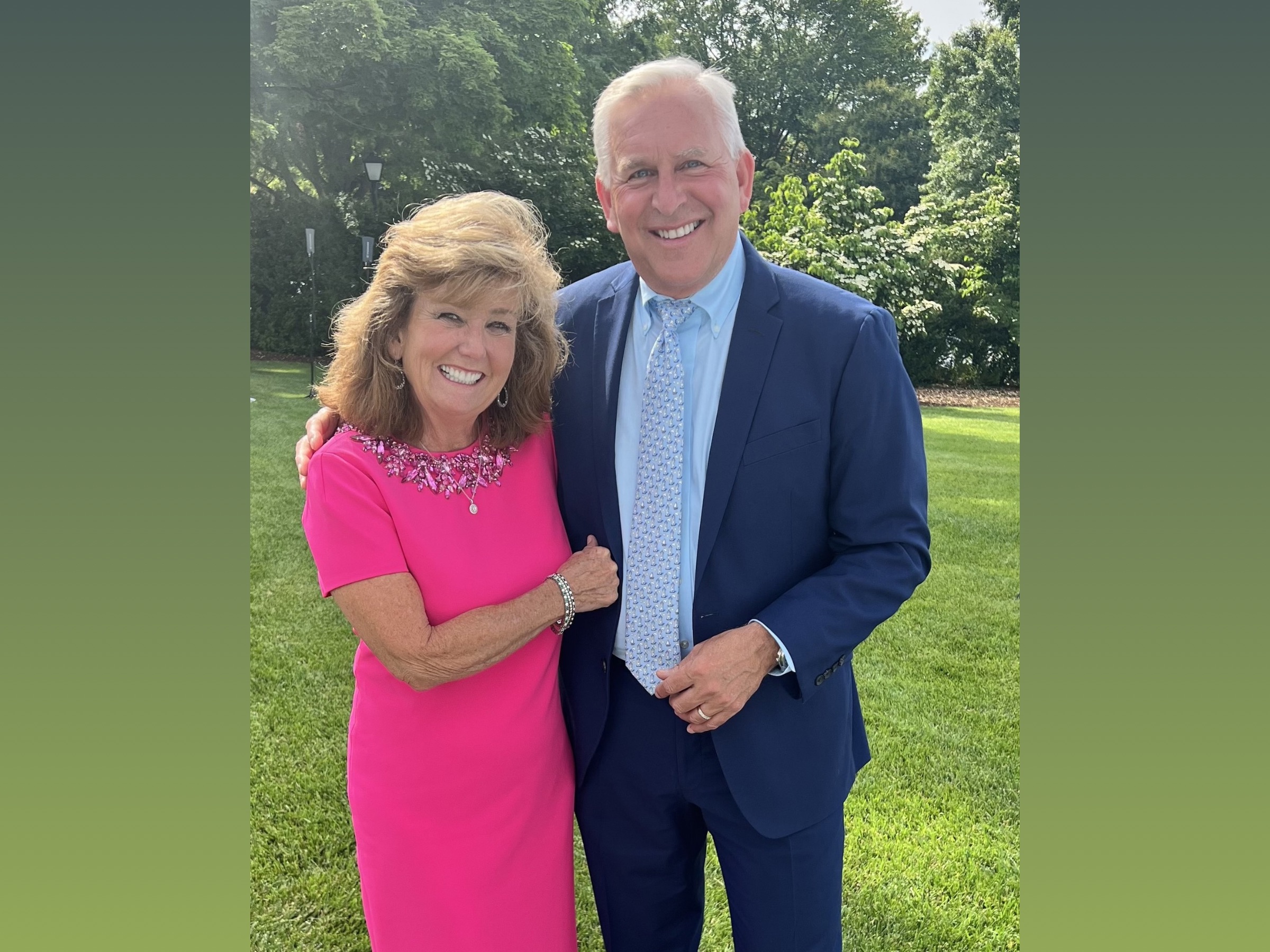 Stephen Pace and Rita Pace, smiling and standing outside in front of some trees