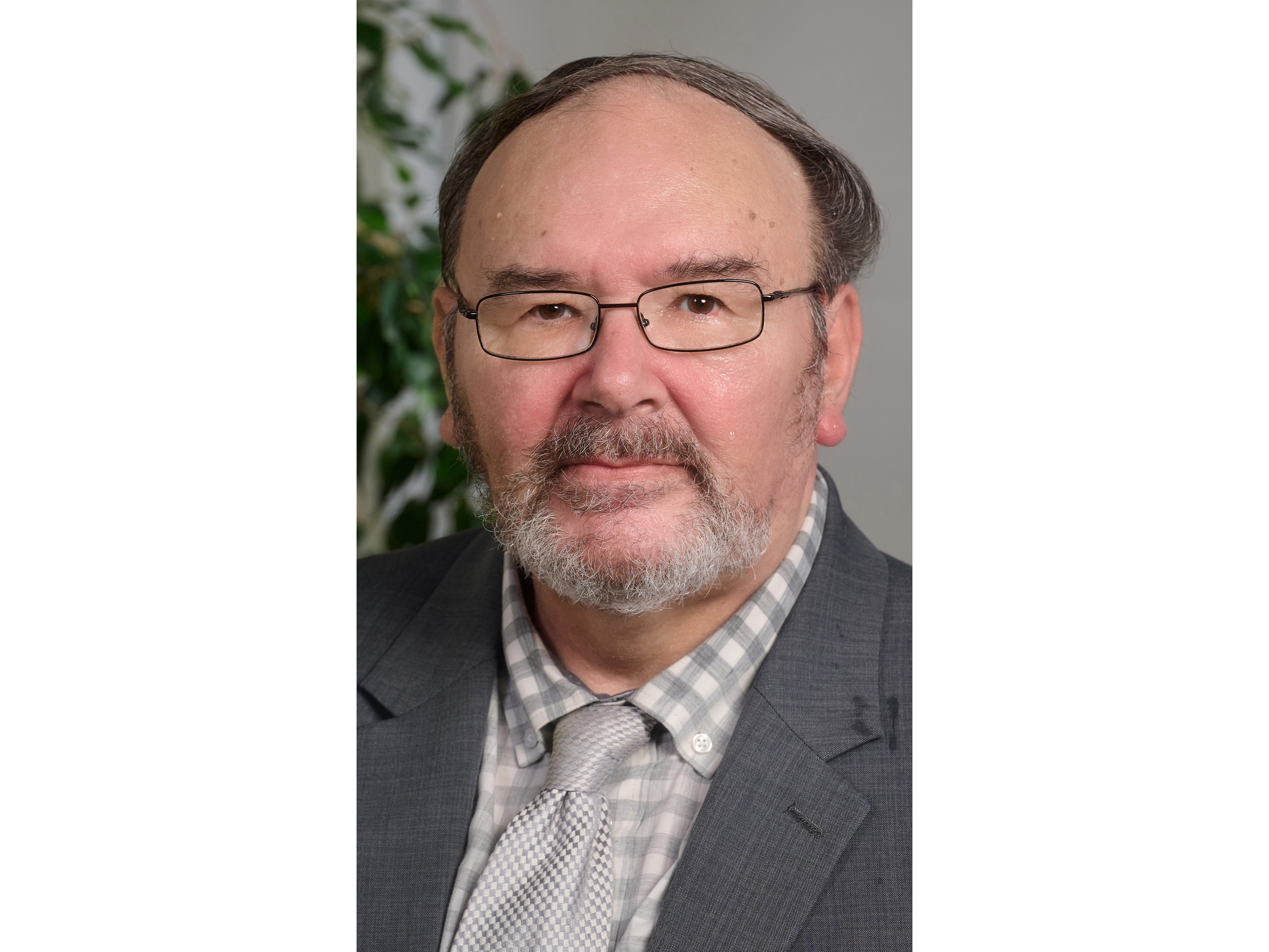 Portrait of Dr. William Rothwell wearing a dark gray jacket and silver tie.