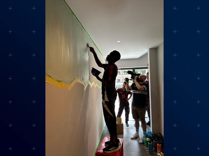 Teen boy painting a mural