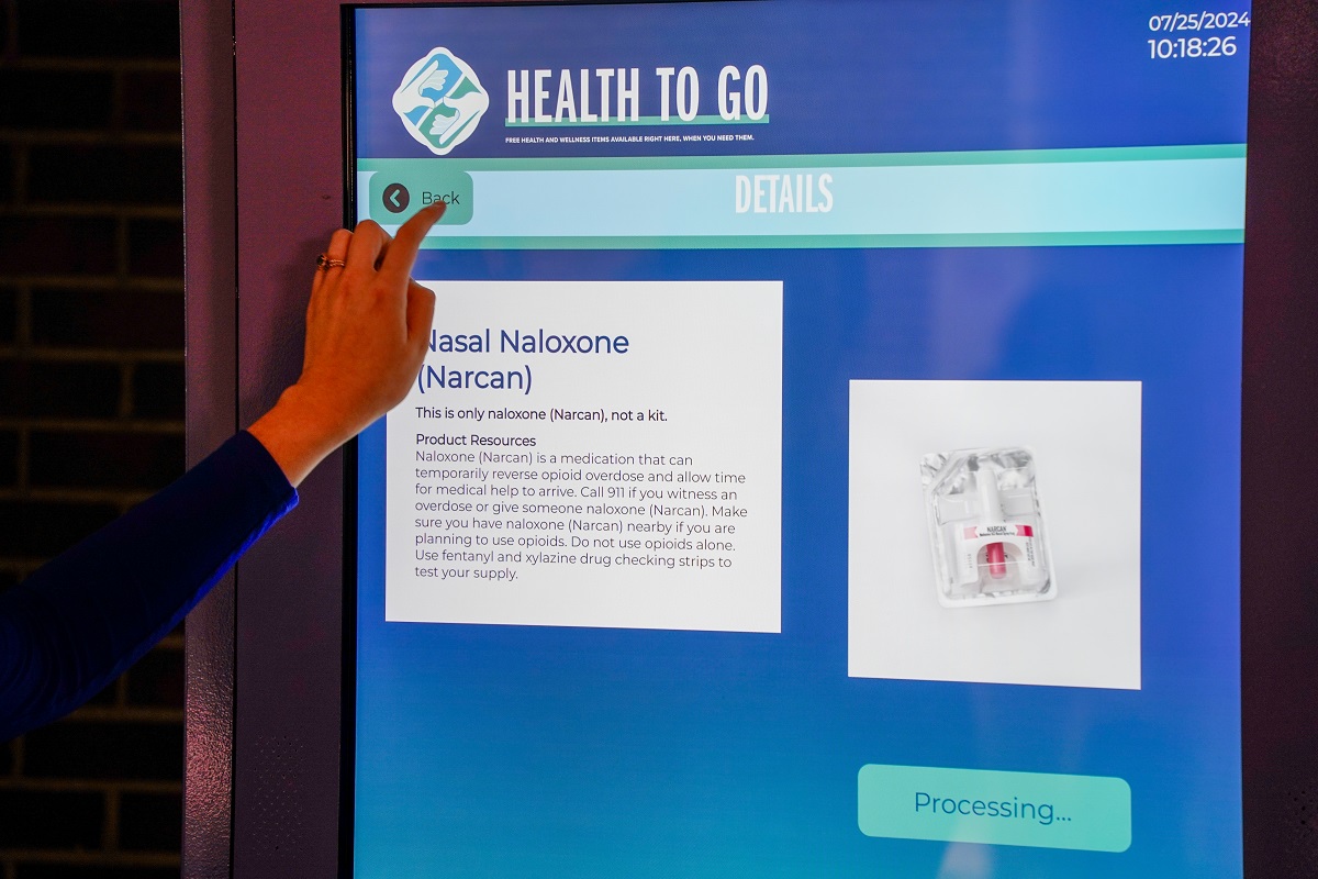 Photo shows the touch screen of an interactive vending machine that dispenses health care items