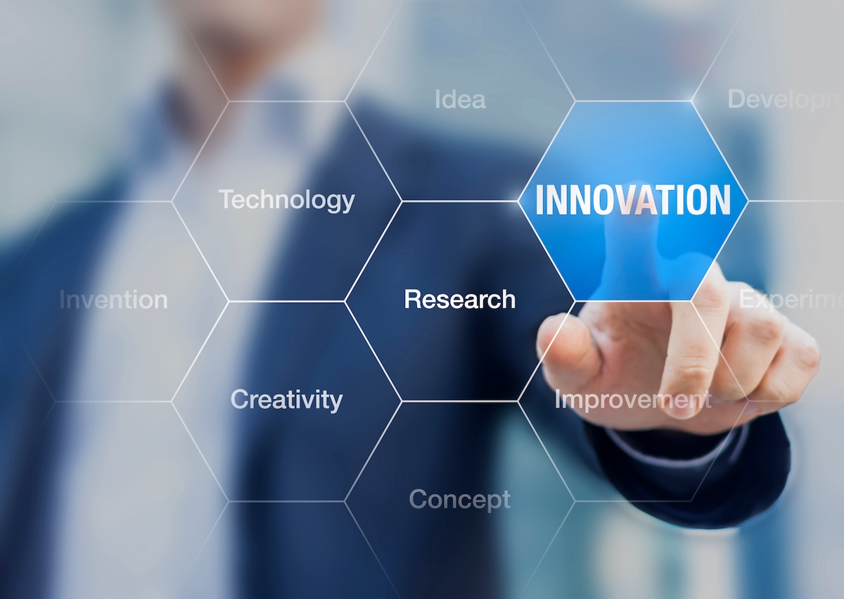 Decorative image - person at clear "white board" pointing to the word "innovation"