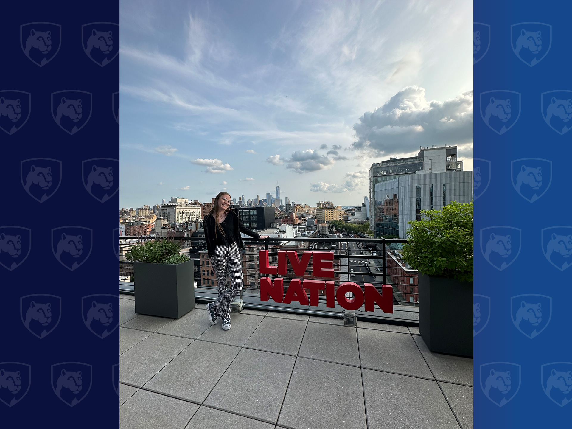 Woman standing on roof with Live Nation sign in red