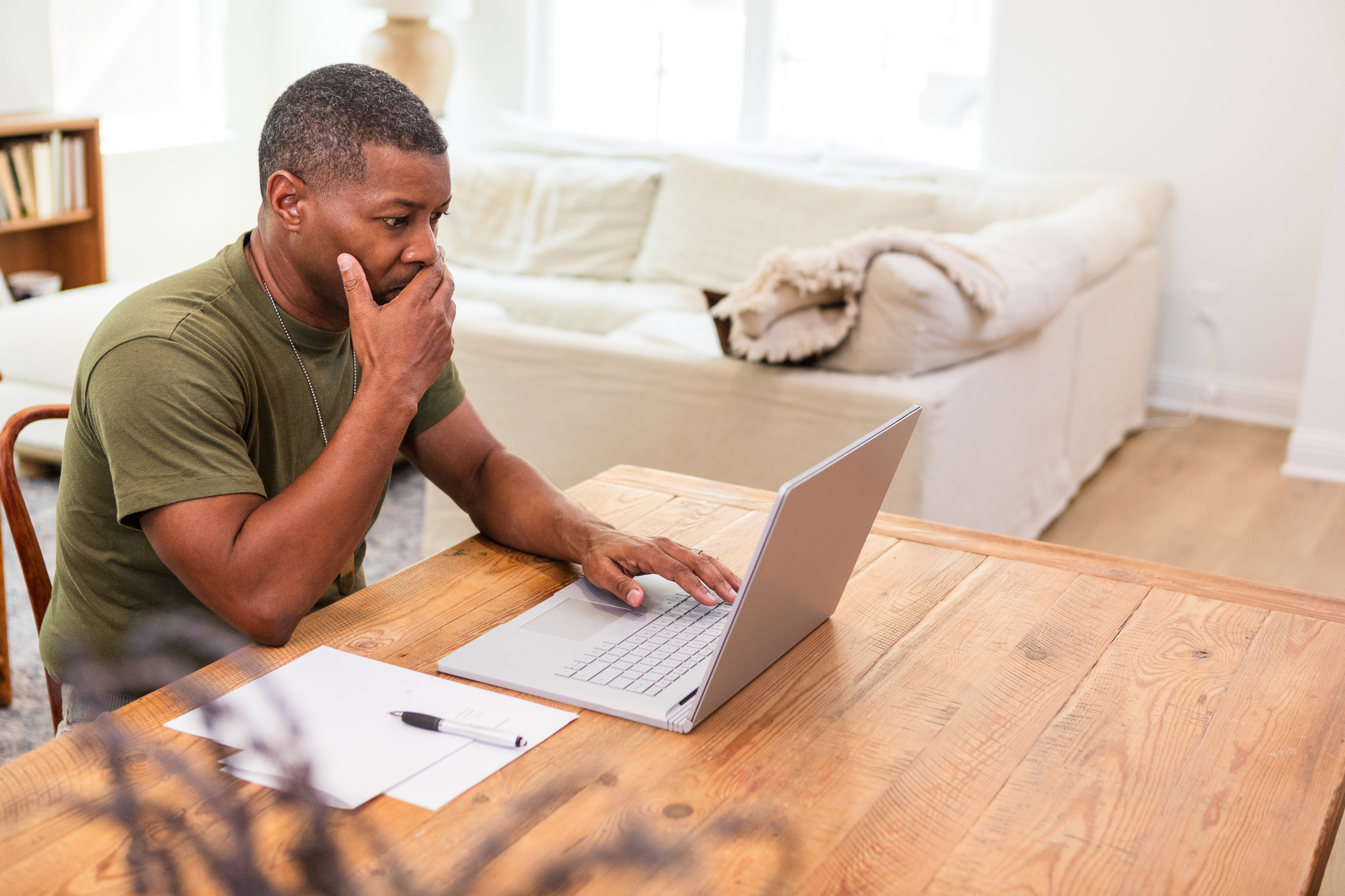 Person sits in front of a laptop