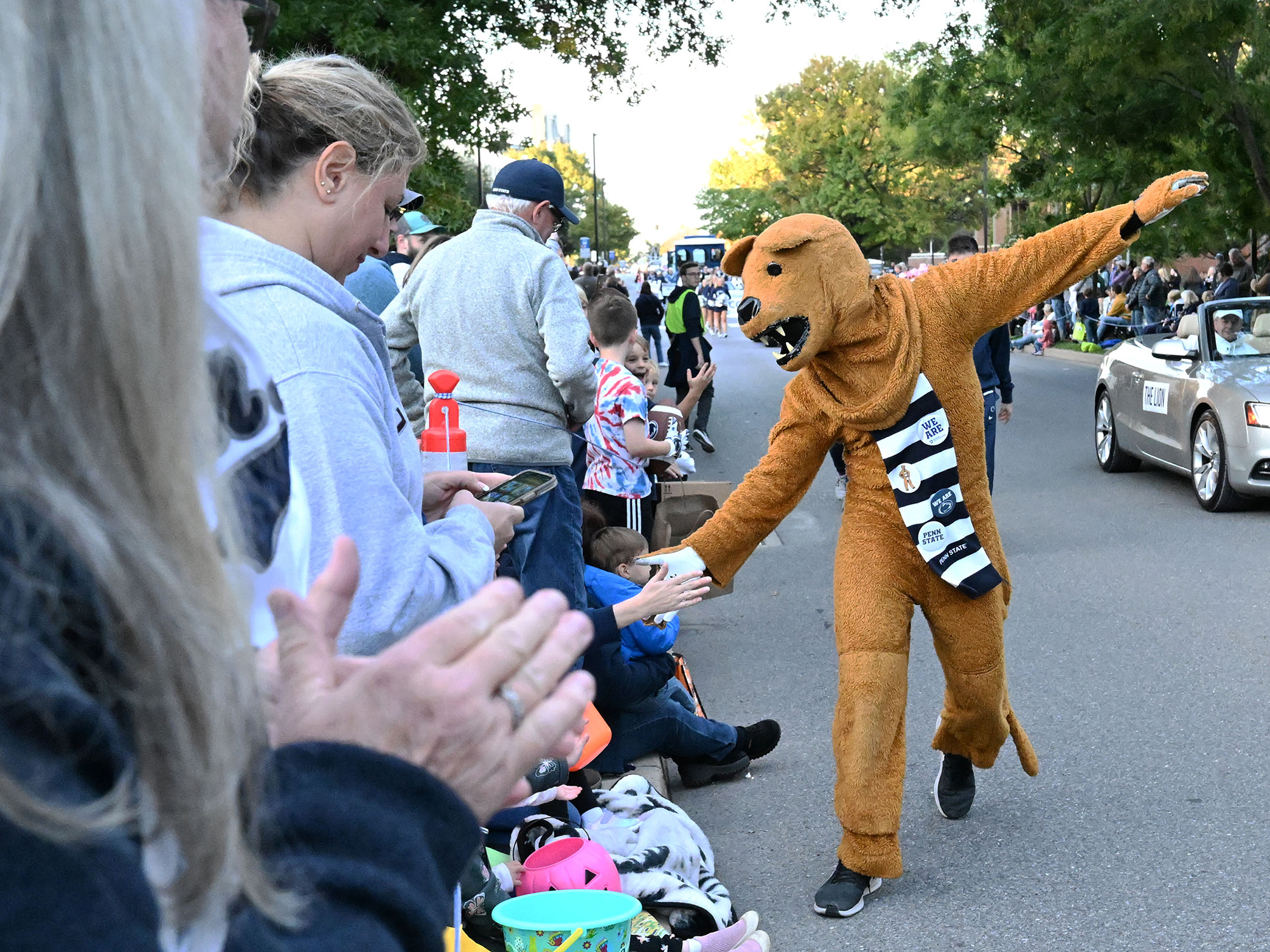 Nittany Lion high-fiving Penn Staters during Homecoming Parade