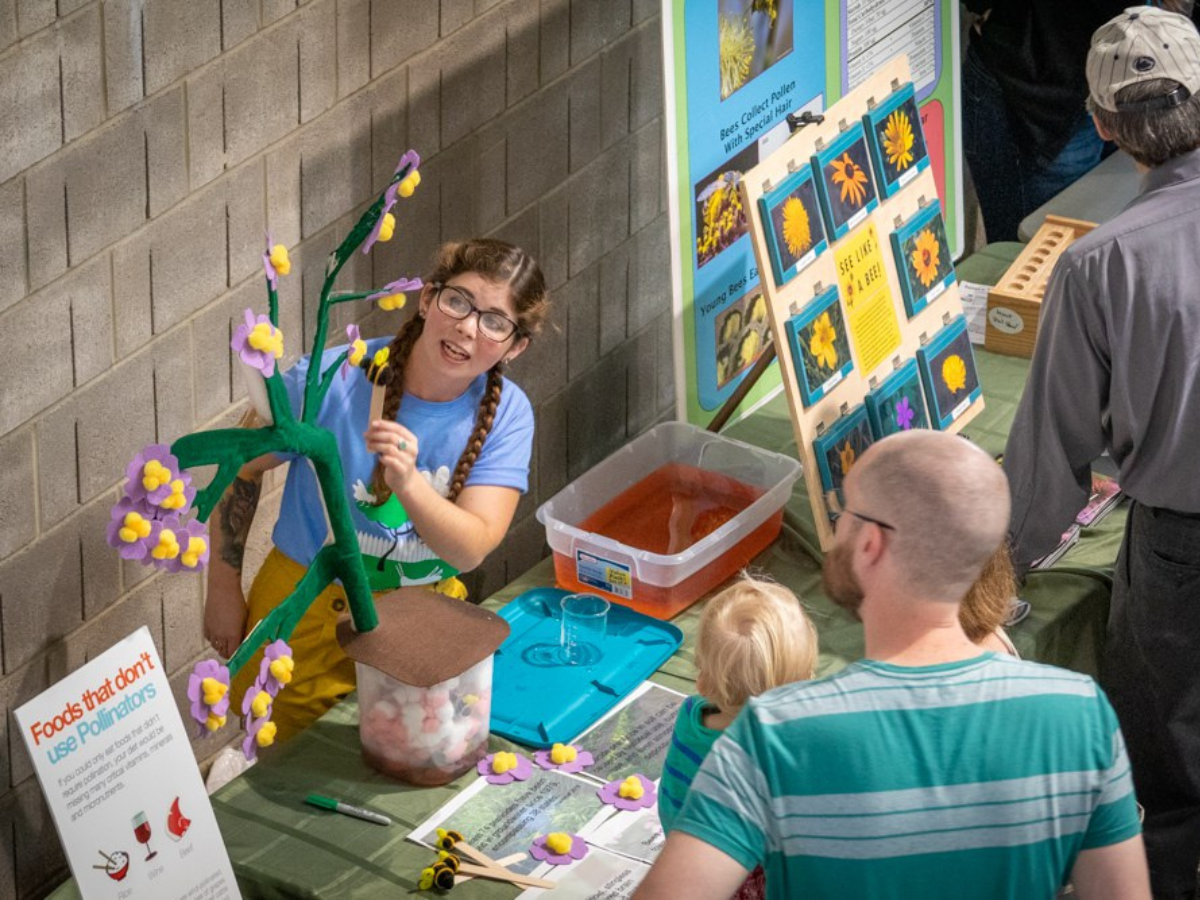 A woman leading a demonstration about pollinators at a previous year's fair.