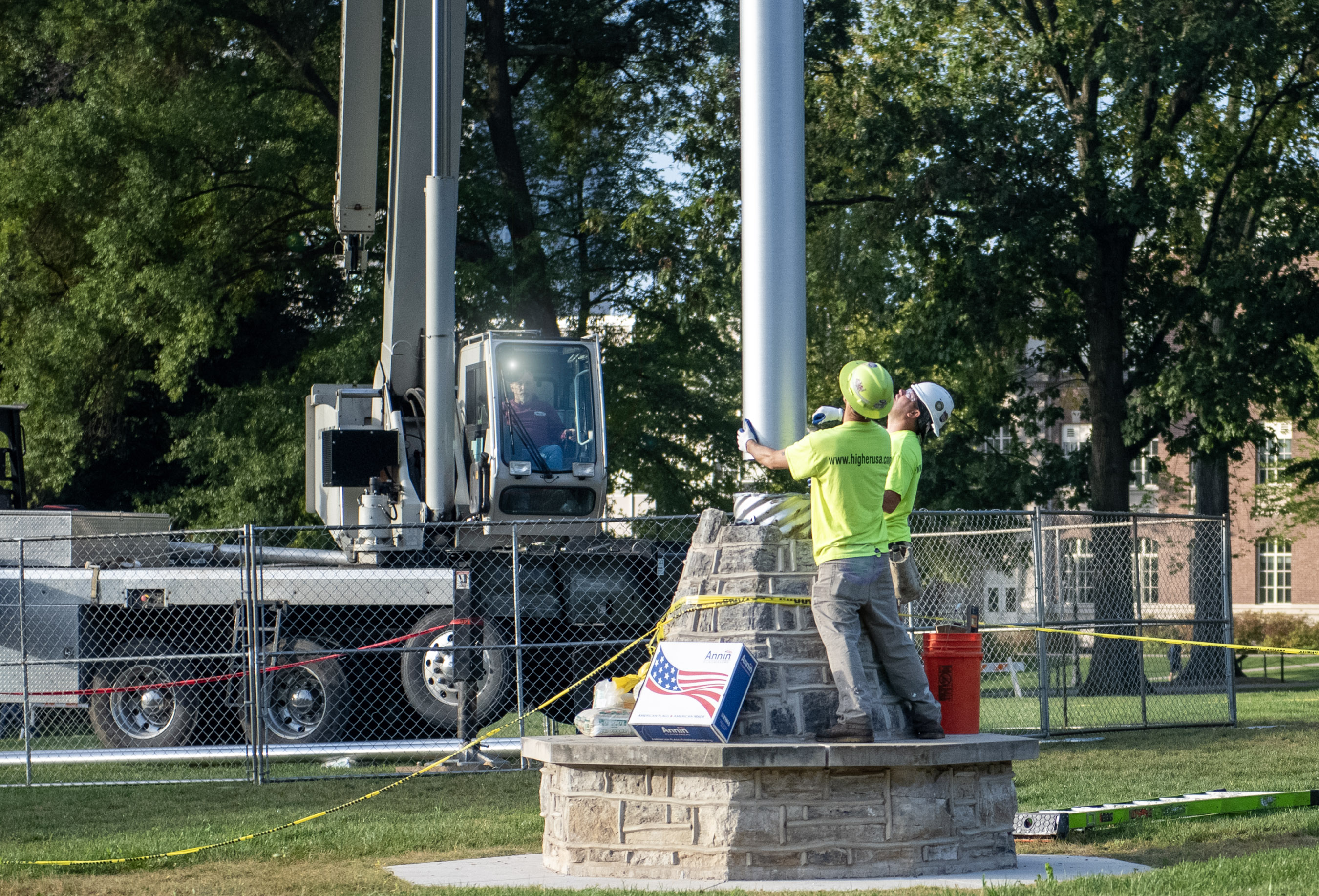 guiding new flag pole into base