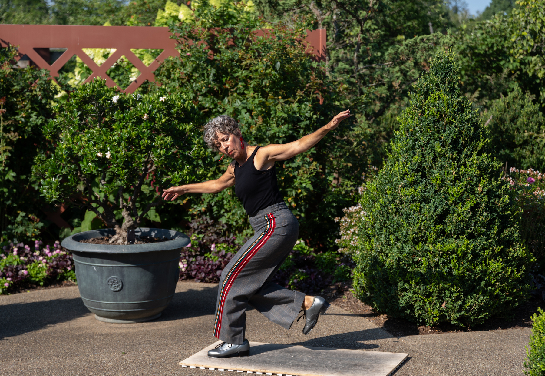 Woman tap dancing among trees