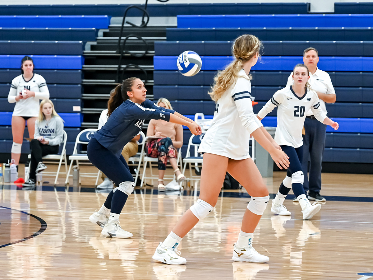 Penn State Altoona volleyball player hits a volleyball during a match