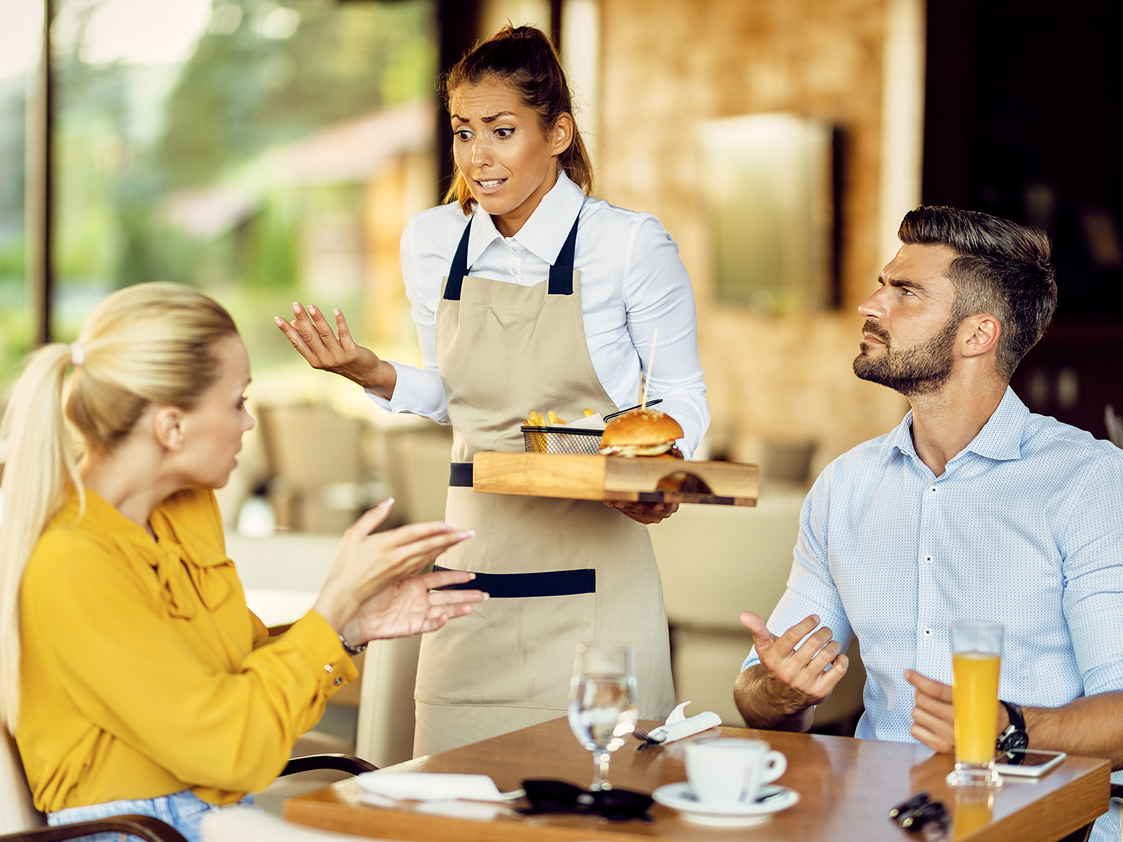 Waiter speaking with customers