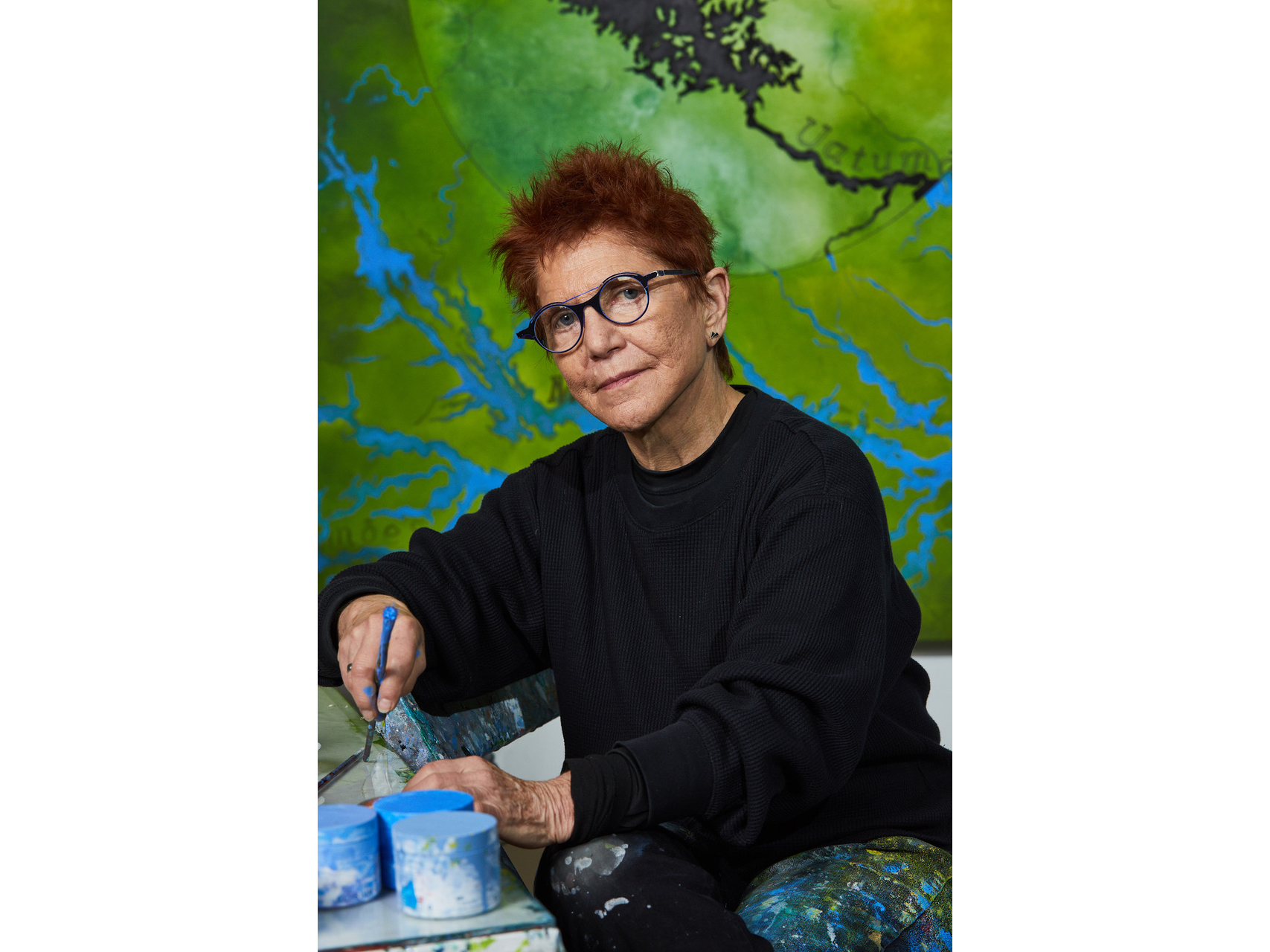 Diane Burko poses in her studio