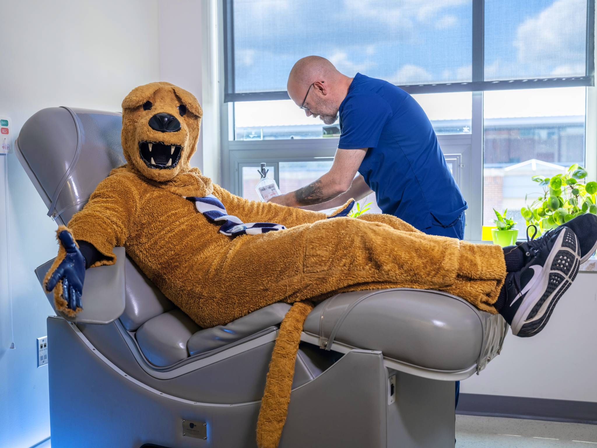 The Nittany Lion gets a vaccine from a nurse at University Health Services