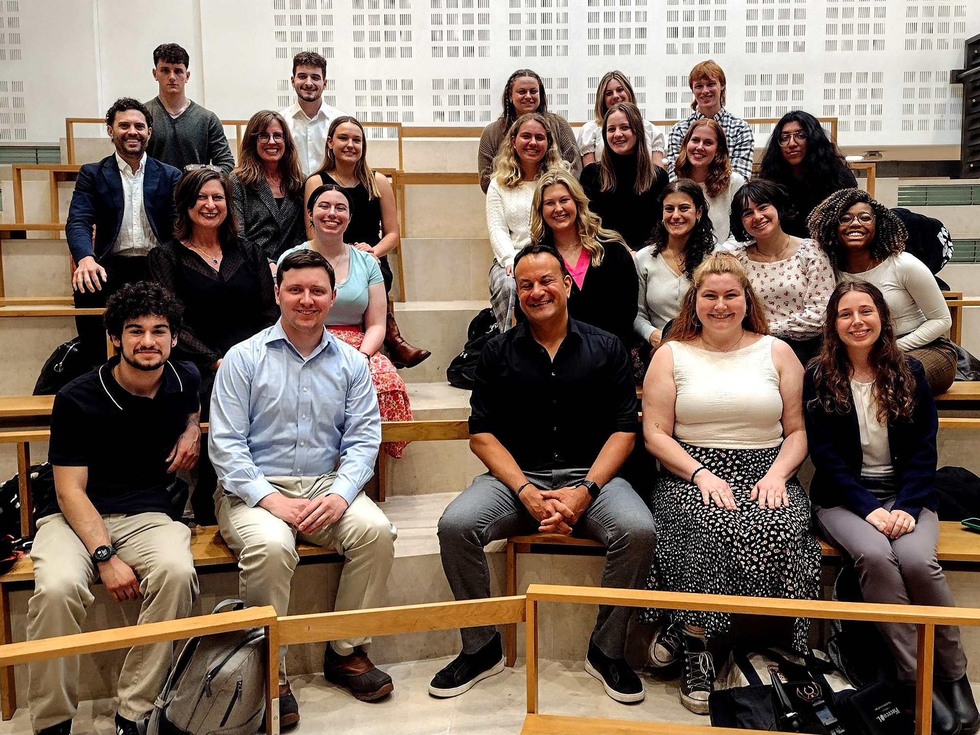 Penn State students and faculty sit in four rows on stairs with Leo Varadkar, former prime minister of Ireland.